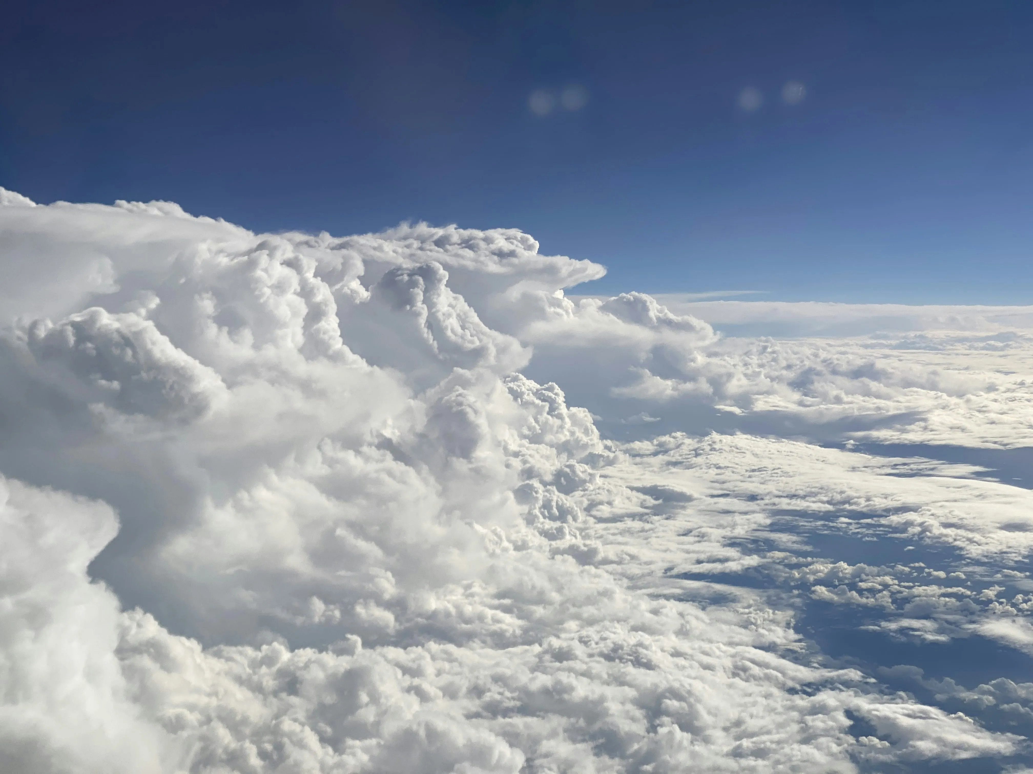 Layered White Clouds Floating Above the Earth Wallpaper