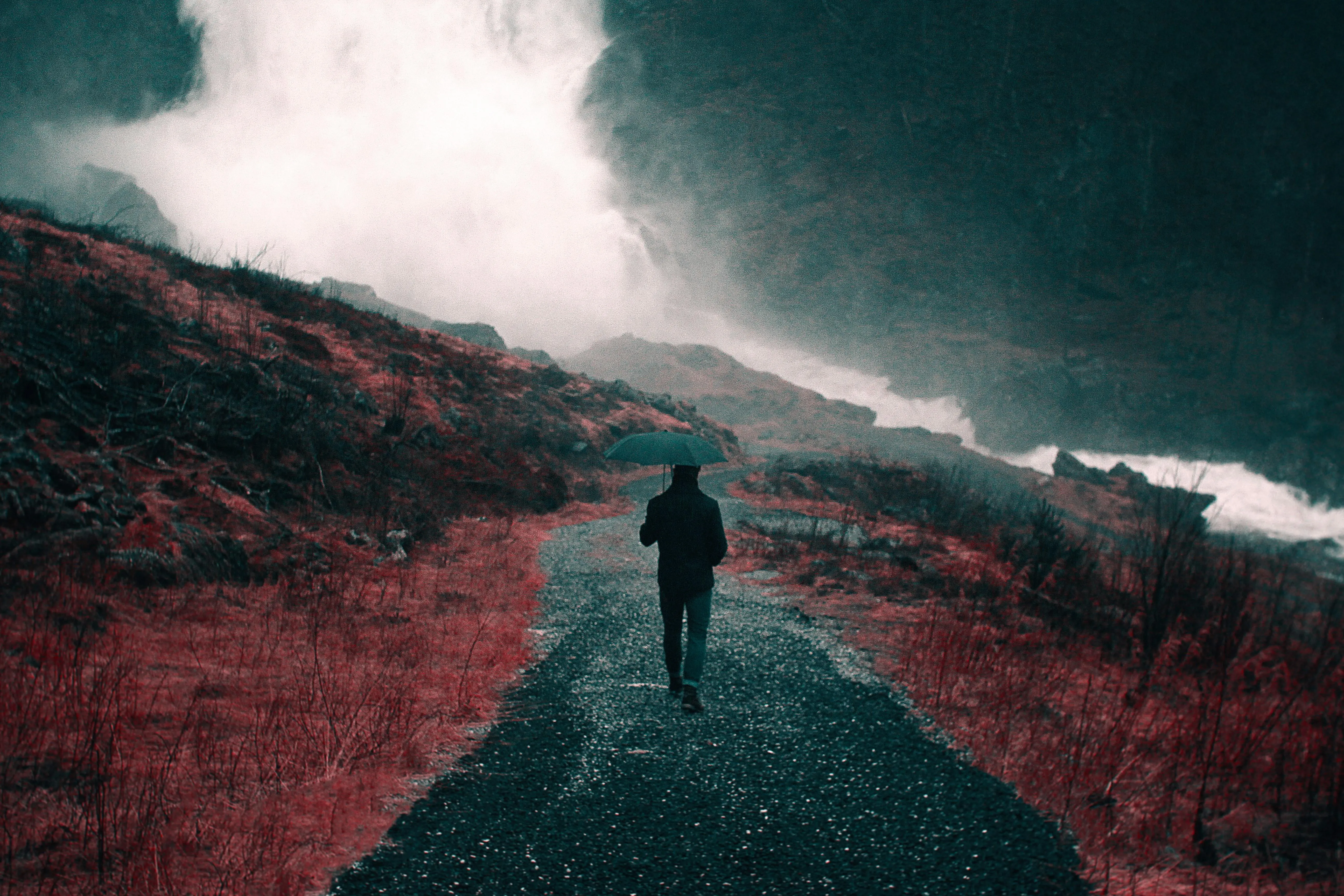 Lonely Person Walking Down Misty Road in Rainfall Image