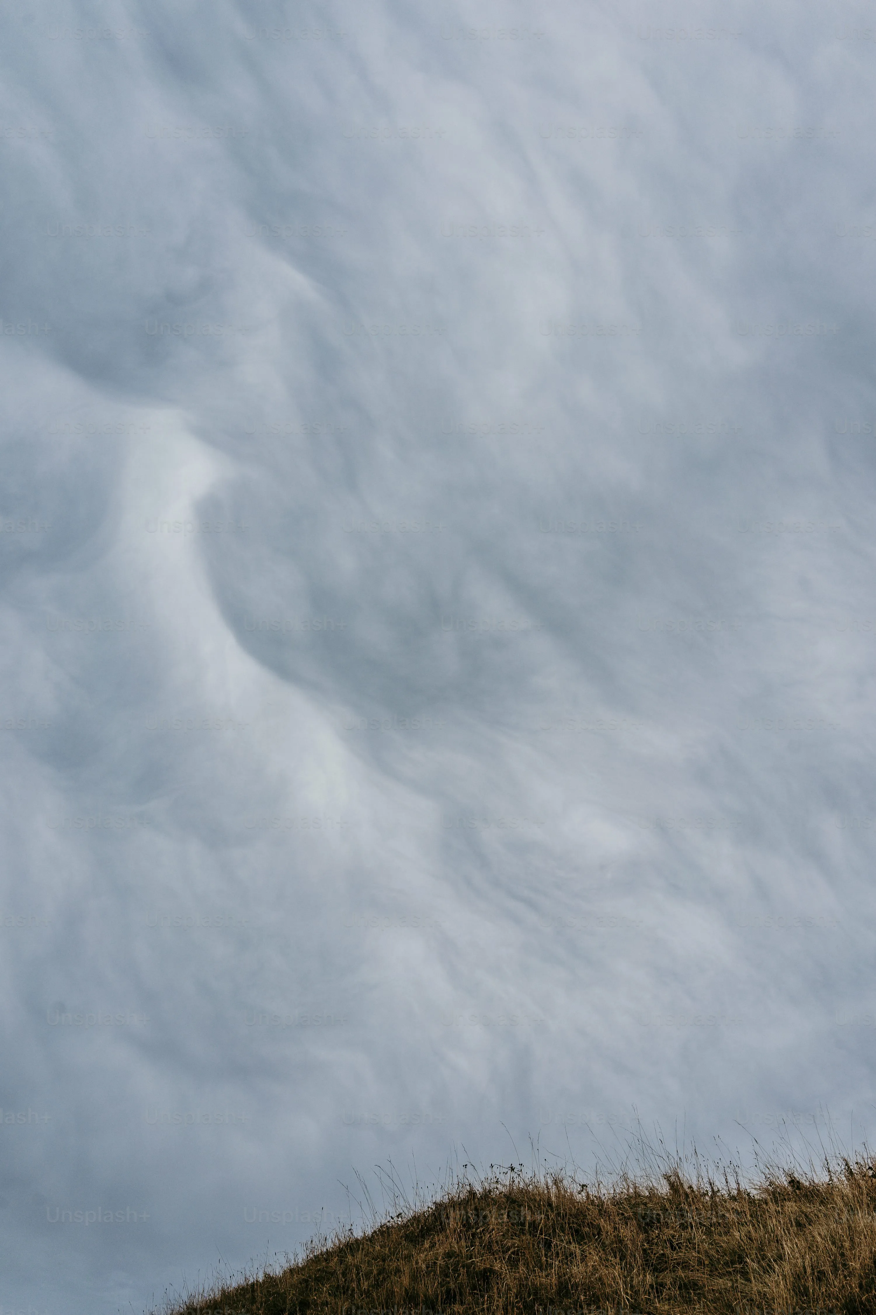 Majestic Cloud Formations Captured Over Rolling Hills