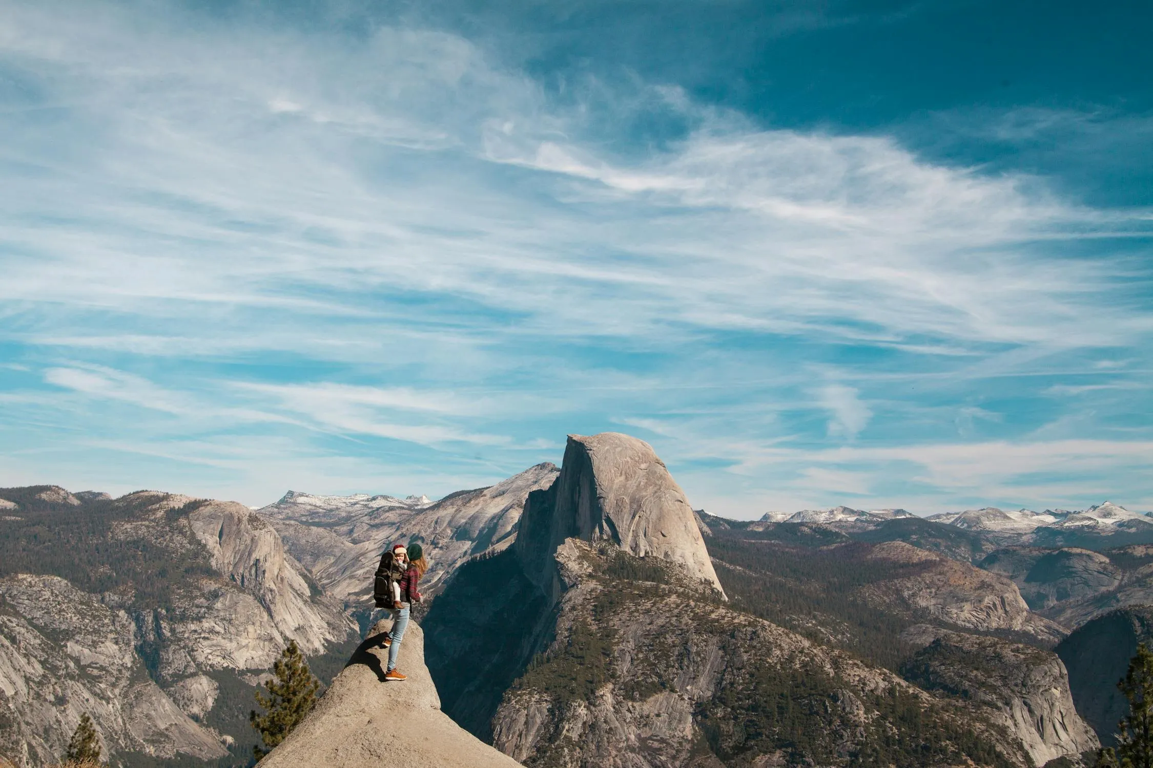 Majestic Mountain Peak Rises Into Clear Blue Sky with Hiker
