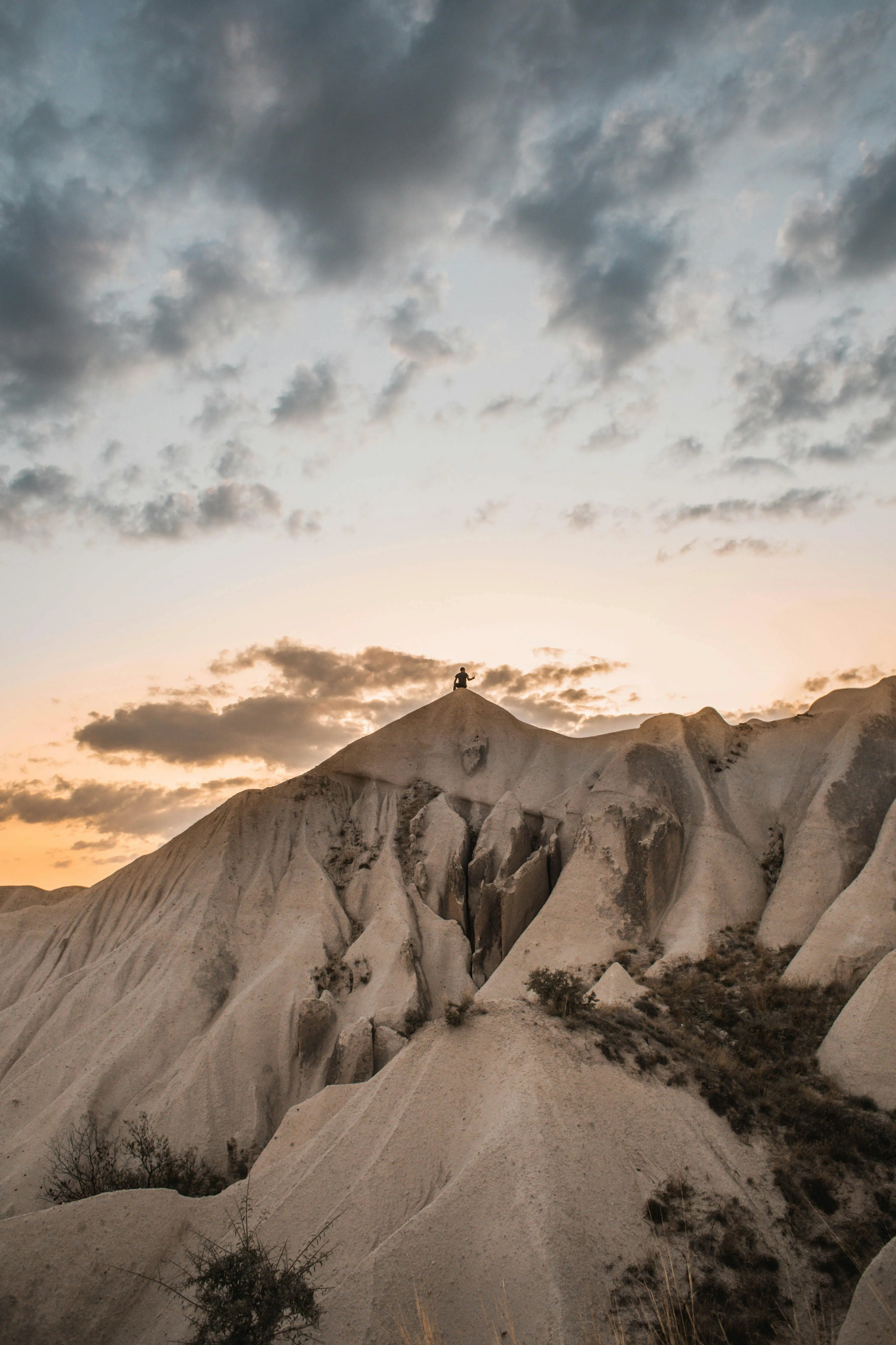 Majestic Mountain Peaks Against a Cloudy Sunset Sky