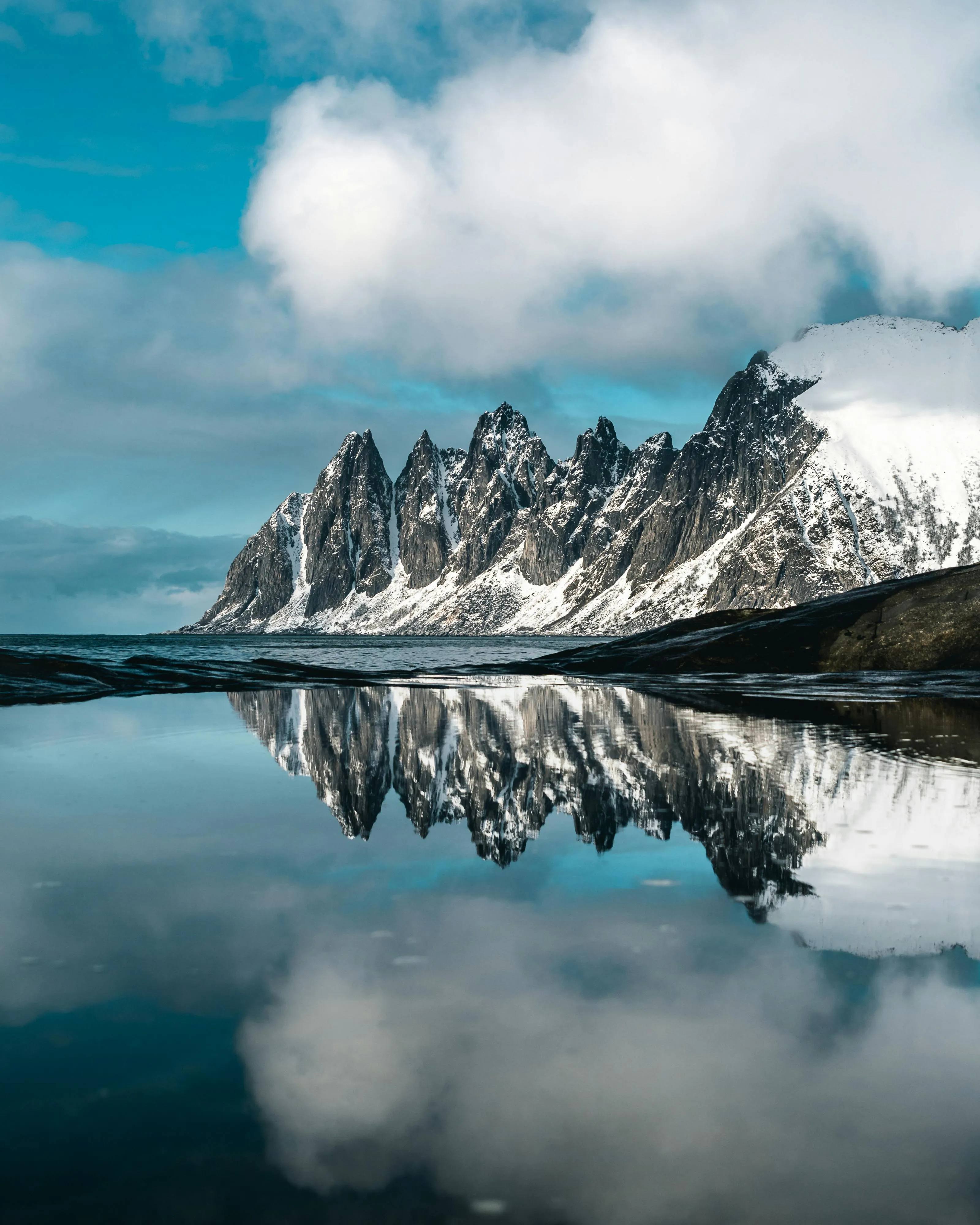 Majestic Snowcapped Mountains Reflected in Calm Lake