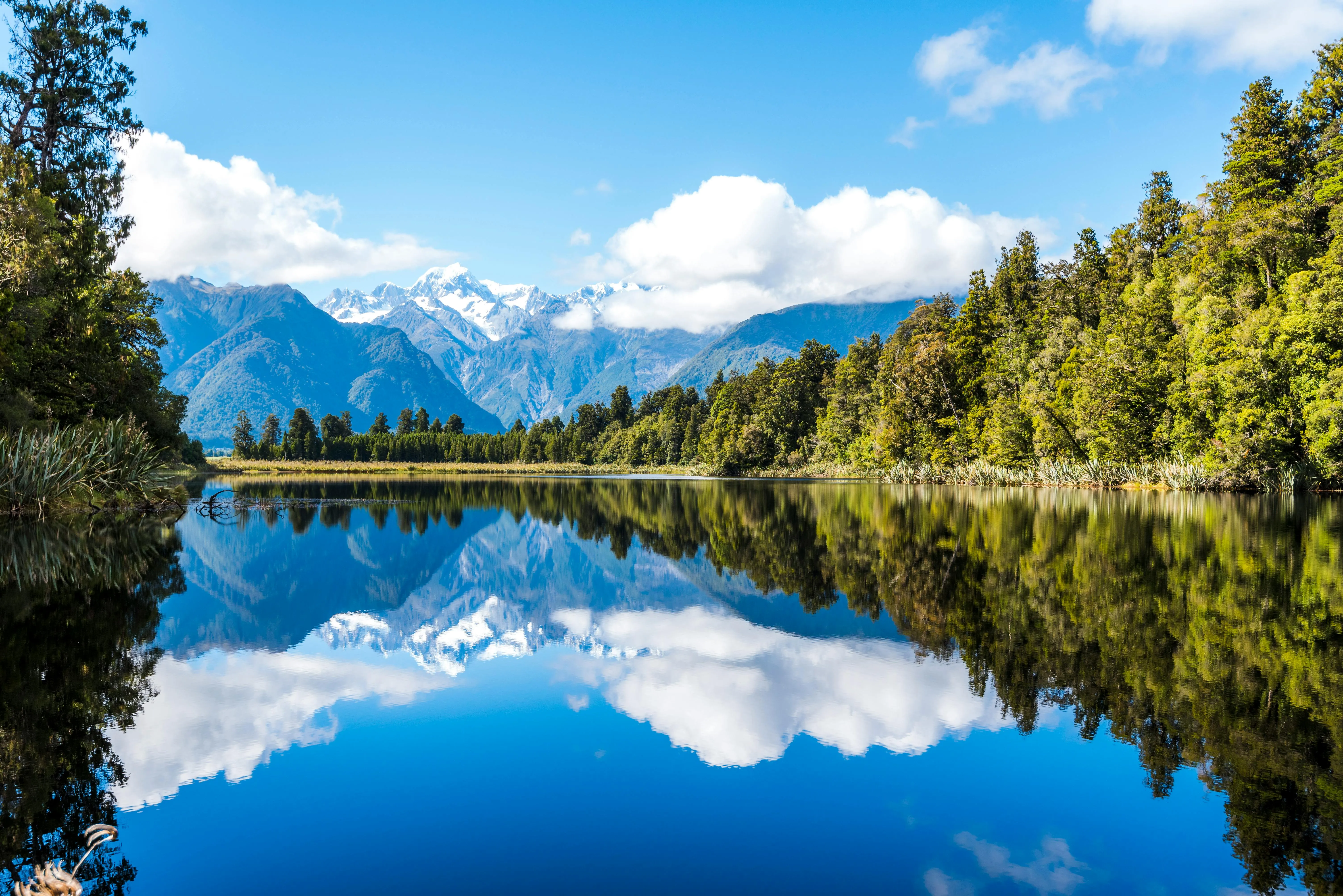 Mirror Reflection of Trees and Sky on Mountain Lake
