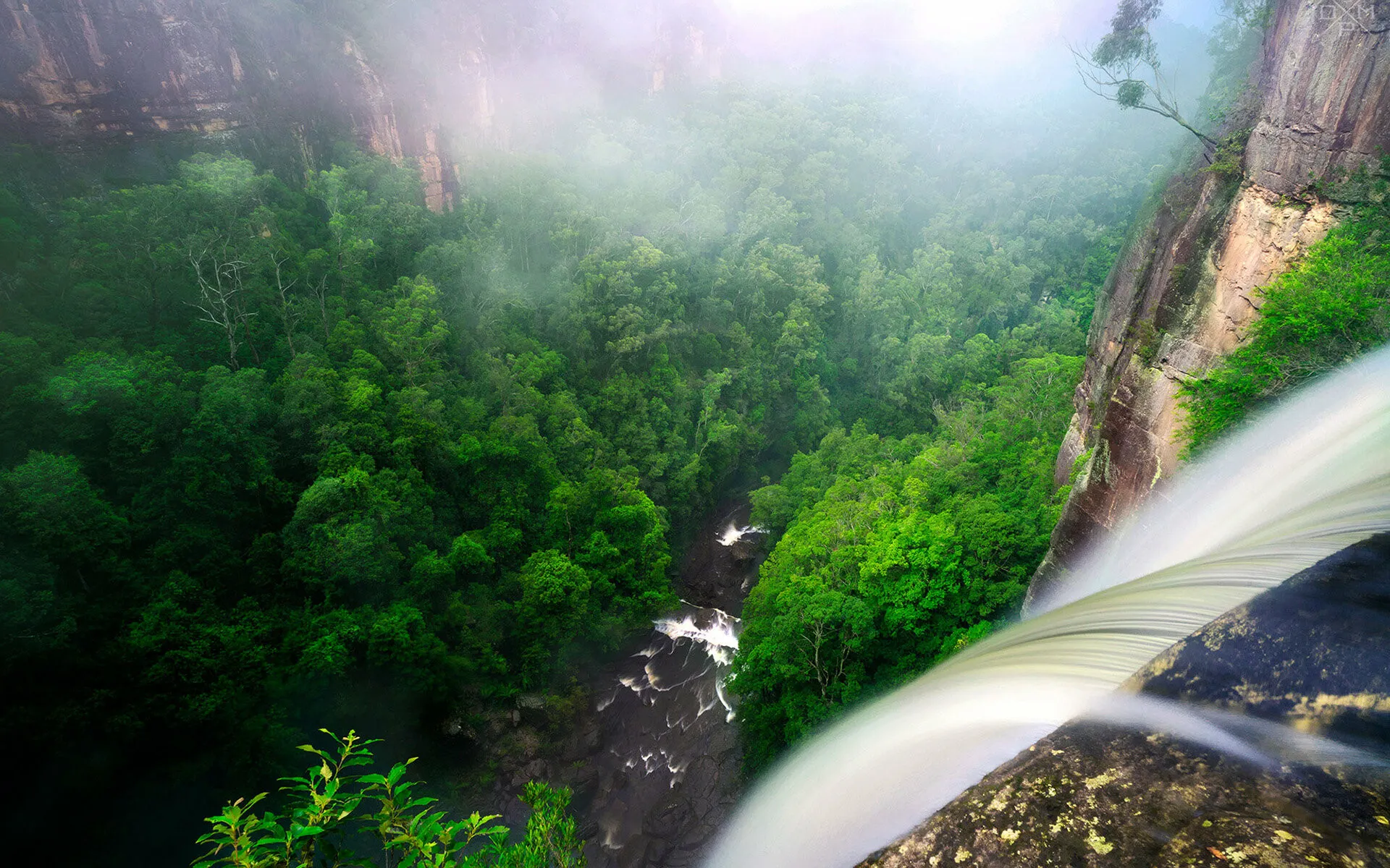 Misty Forest Waterfall Flows Down Rocky Cliffs HD Wallpaper