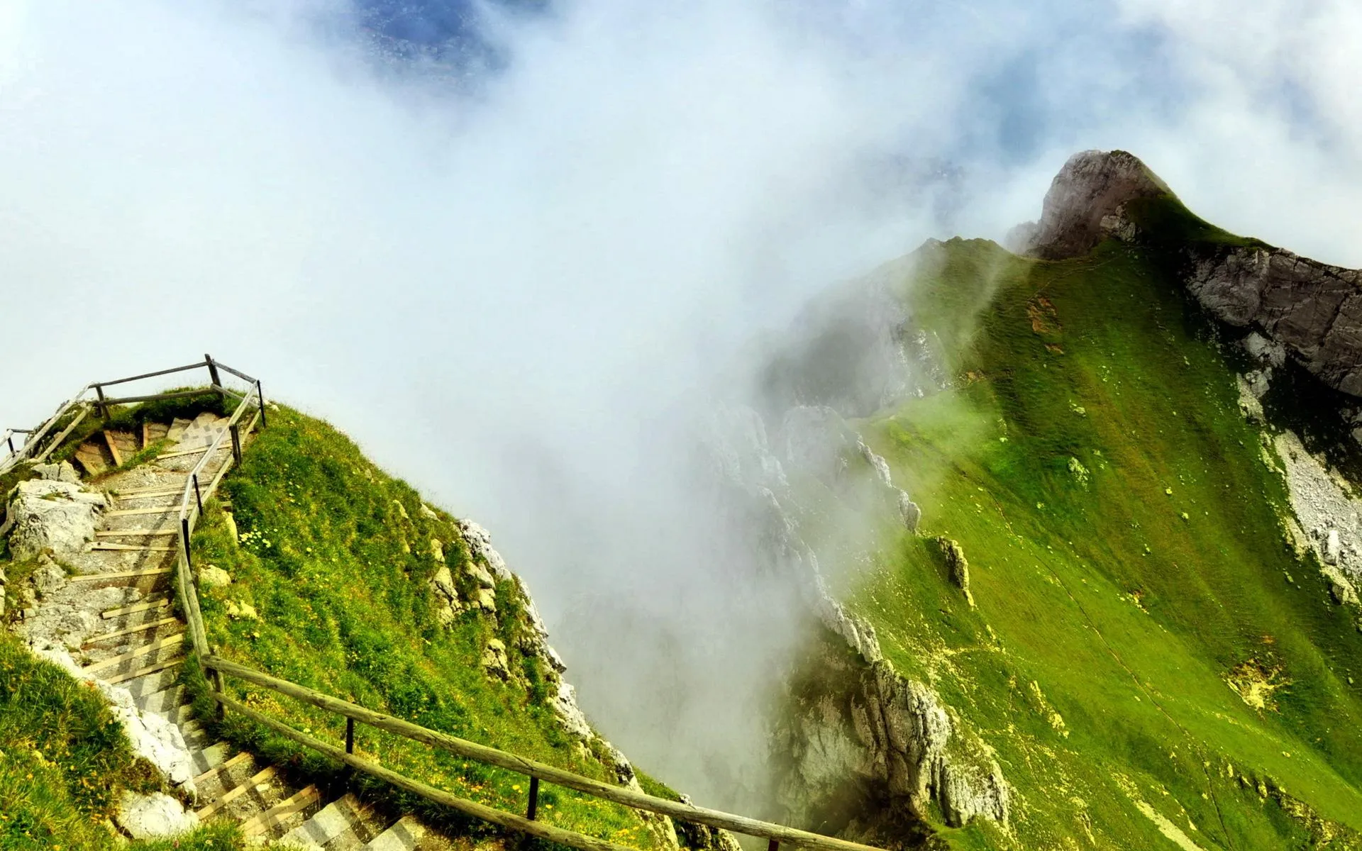 Misty Mountain Peak Covered in Greenery and Clouds