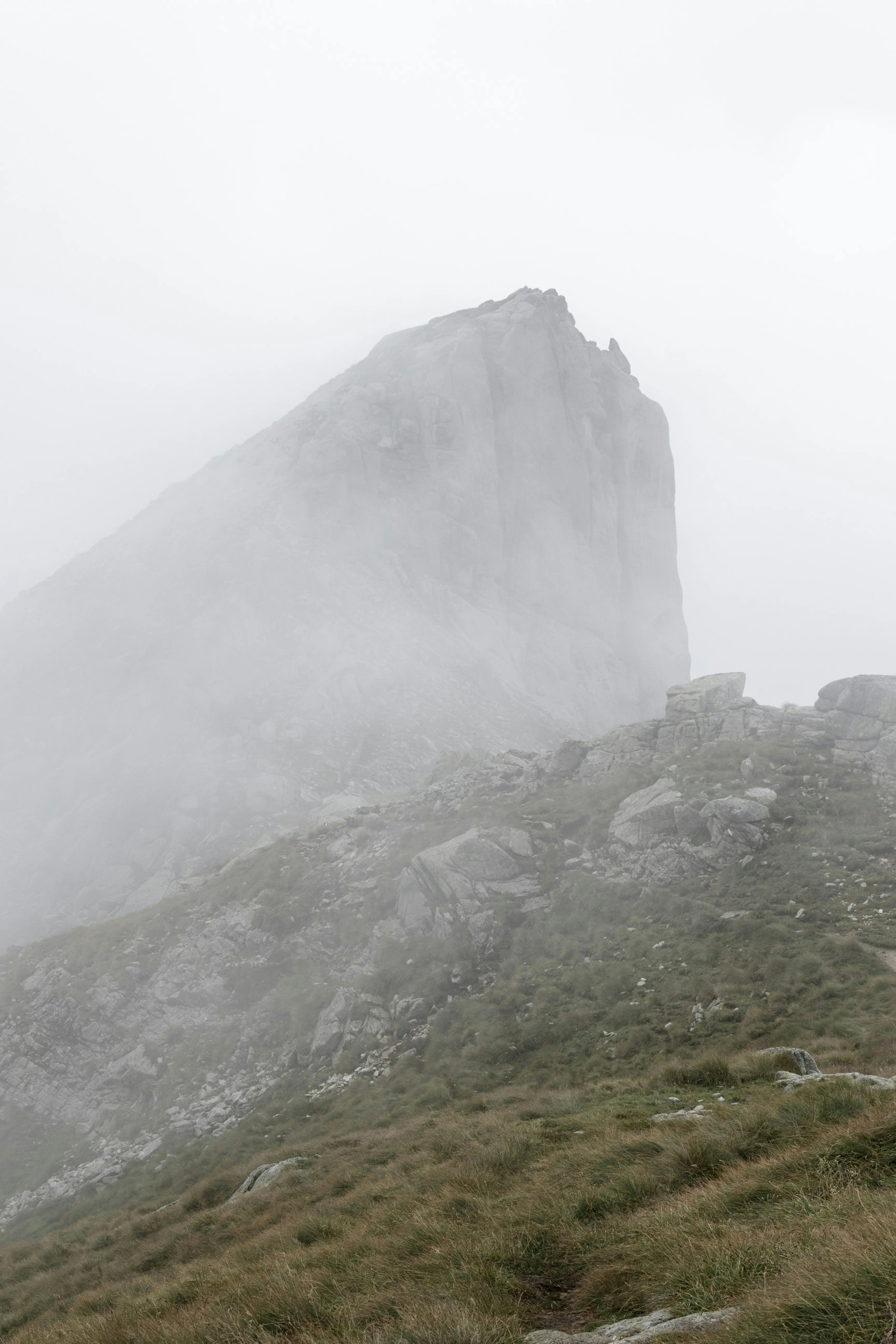 Misty Mountain Peak Surrounded By Clouds and Fog on a Day