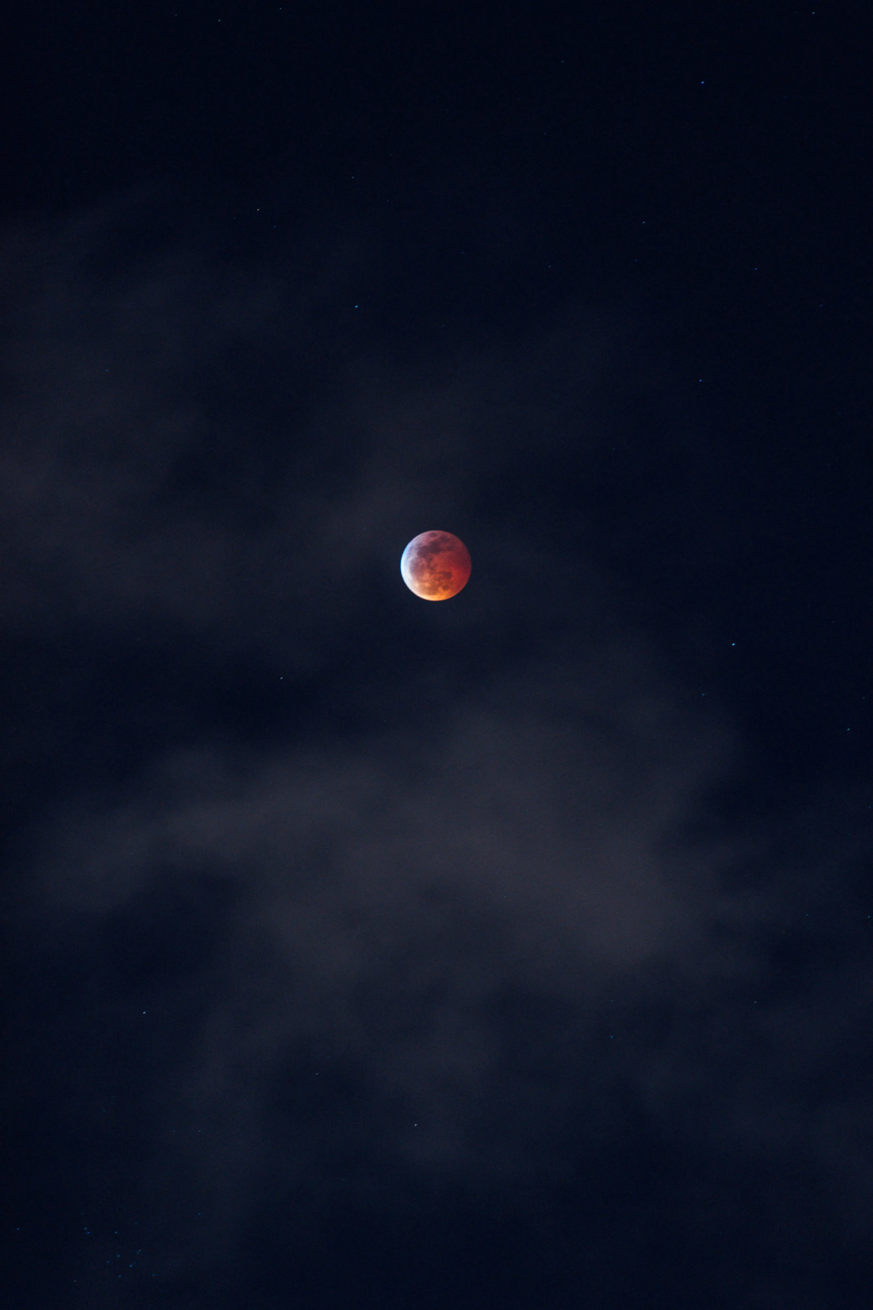 Moon During Eclipse in Dark Sky with Thin Cloud Veil