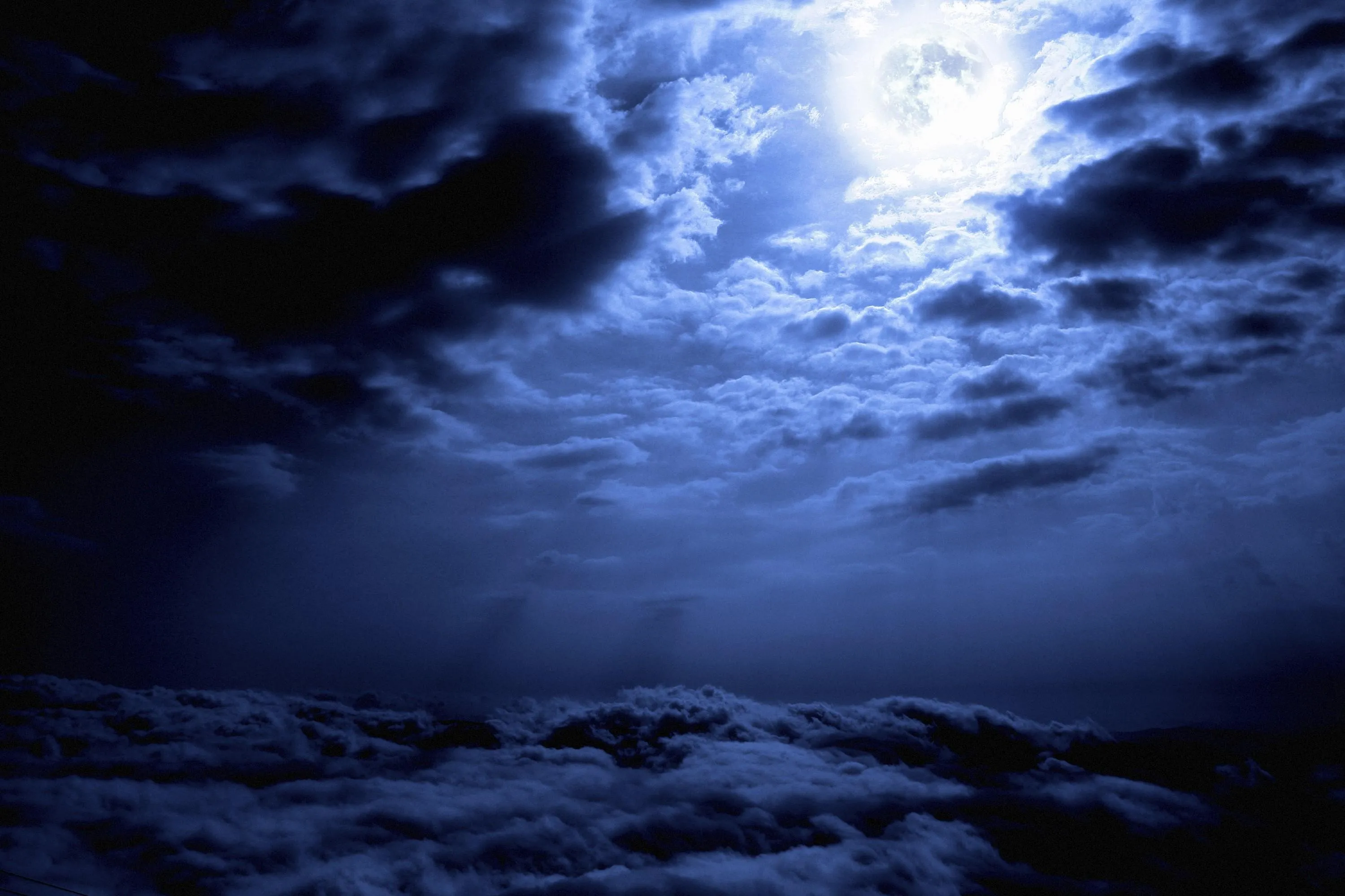Moonlight Illuminating Dark Night Sky with Clouds Wallpaper