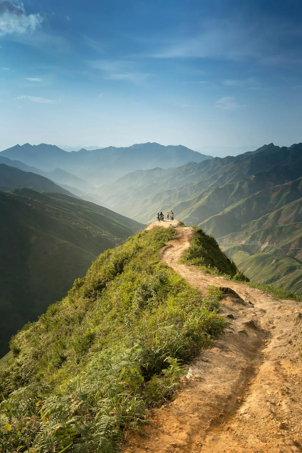 Mountain Hiking Trail Under Clear Blue Sky with Soft Clouds