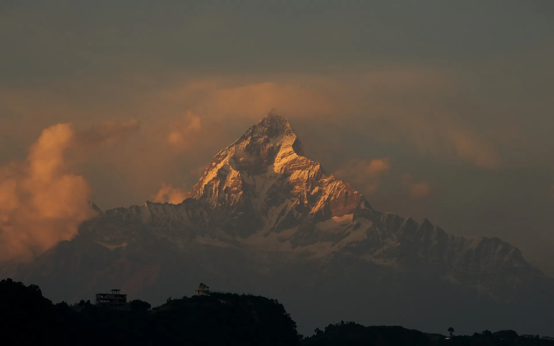 Mountain Peak Glowing Under Dramatic Orange Sunset Sky