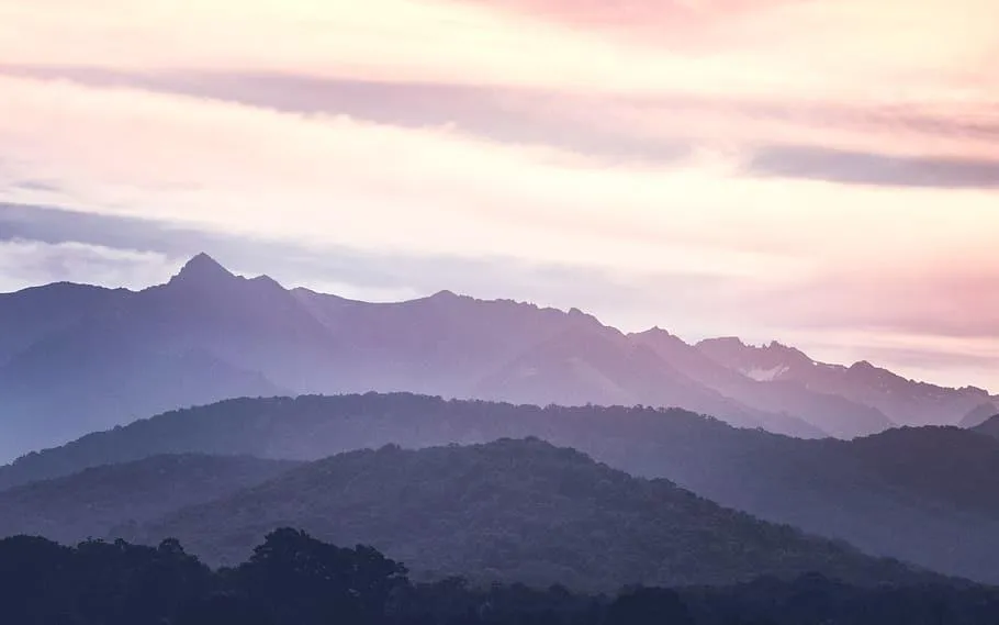 Mountain Range Layers with Soft Purple and Pink Sky