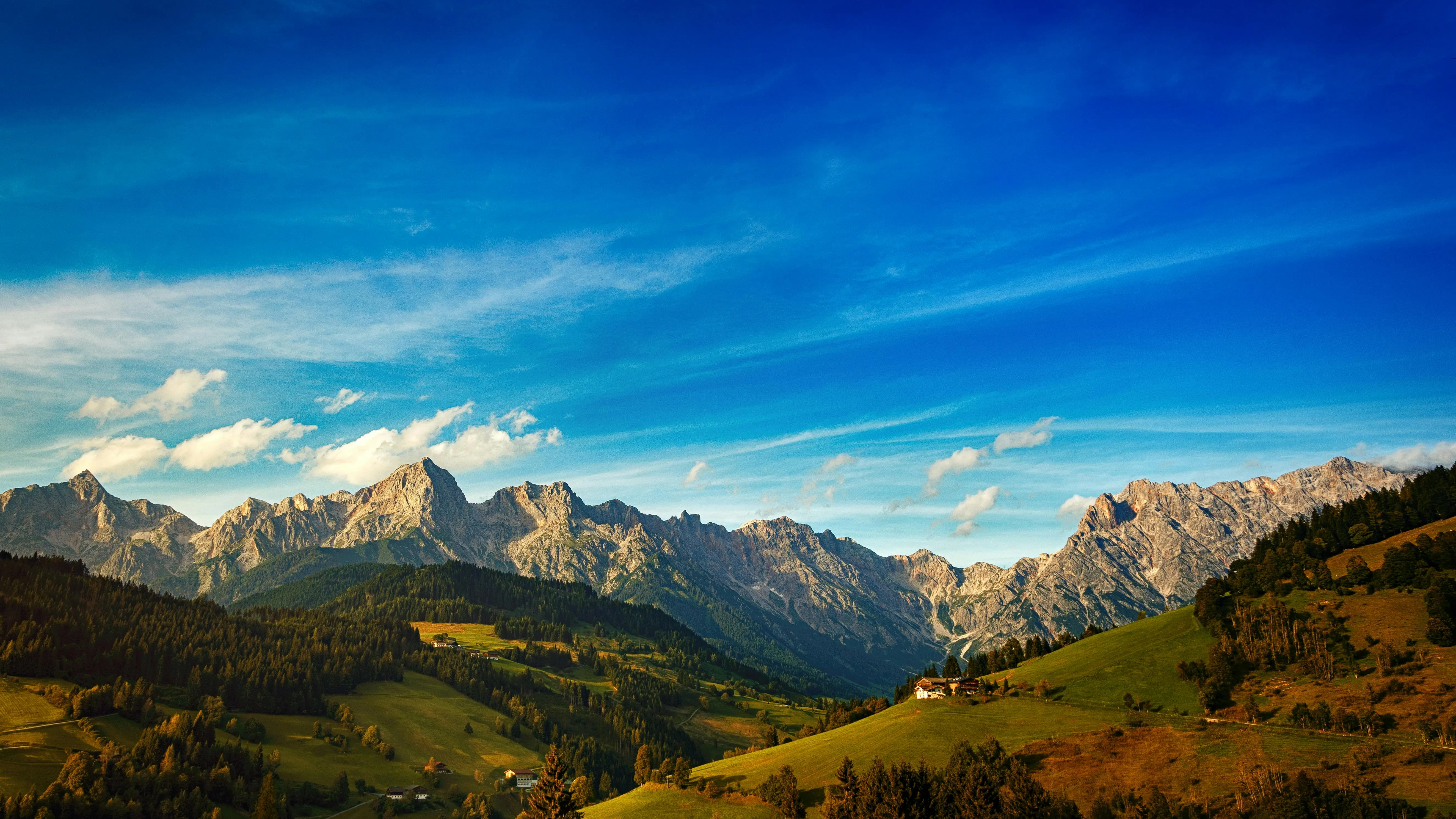 Mountain Range Under Clear Blue Sky and Puffy Clouds