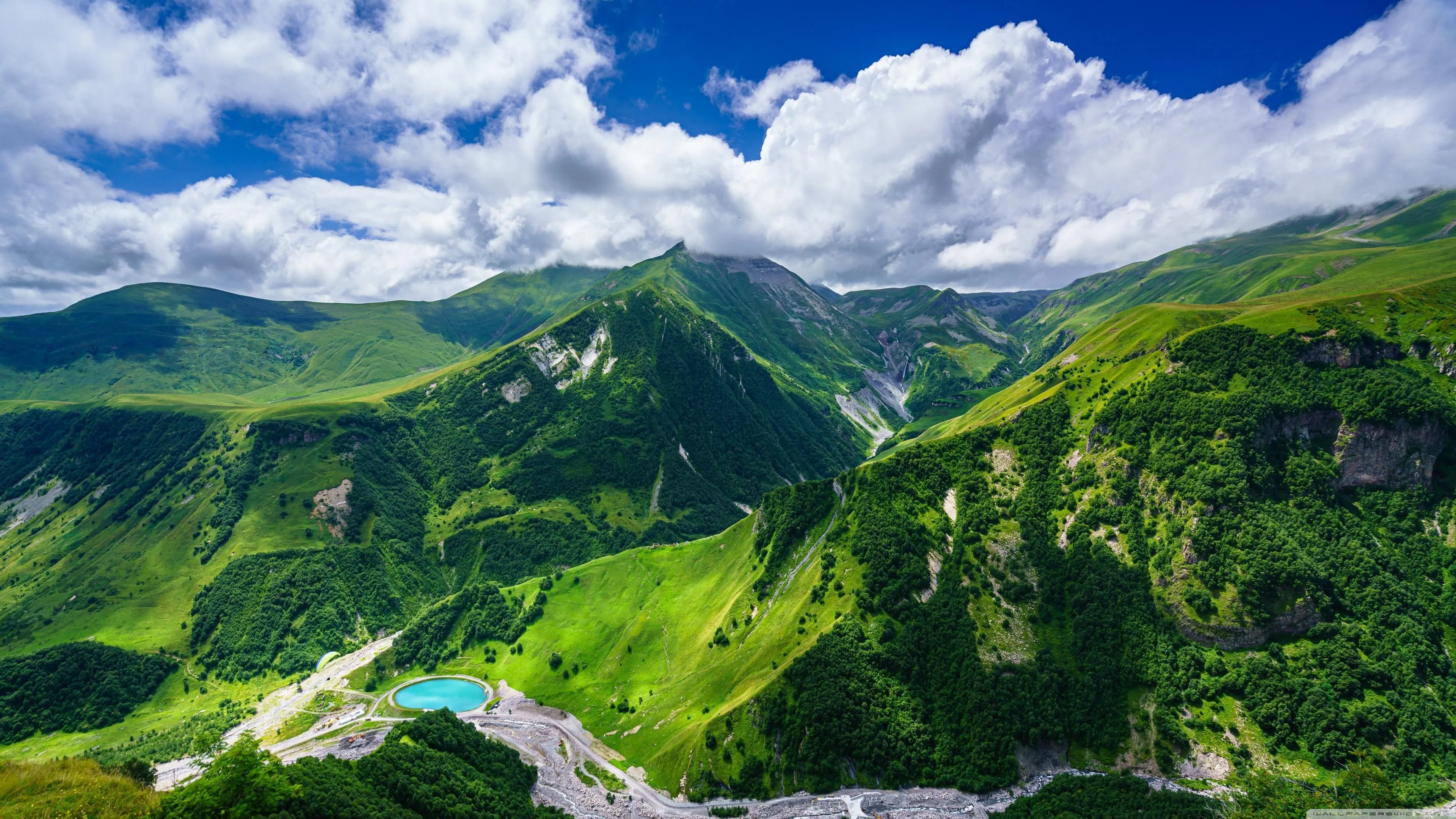 Mountain Range with Green Forests Under Clear Sky Wallpaper