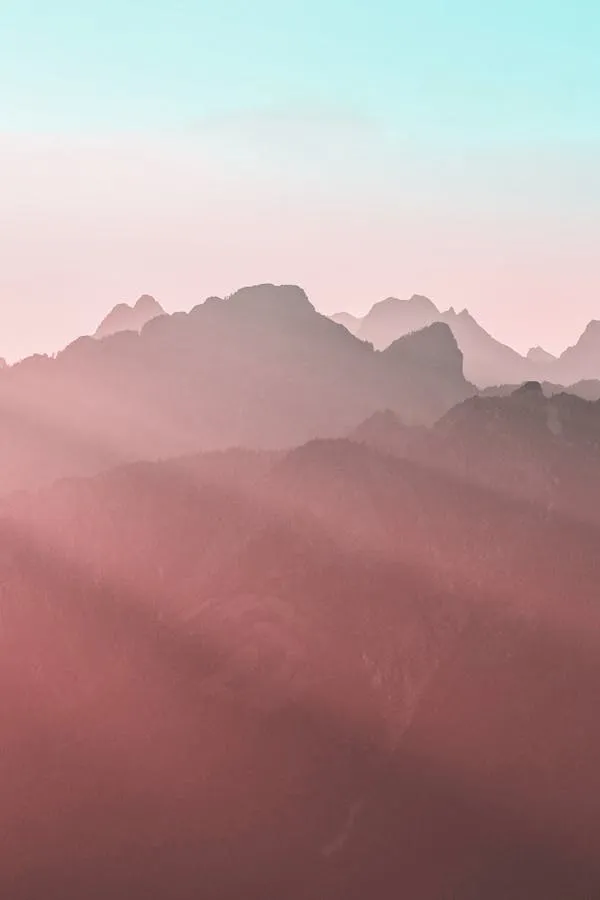 Mountain Ridge Under Morning Light with Pink Tones Wallpaper