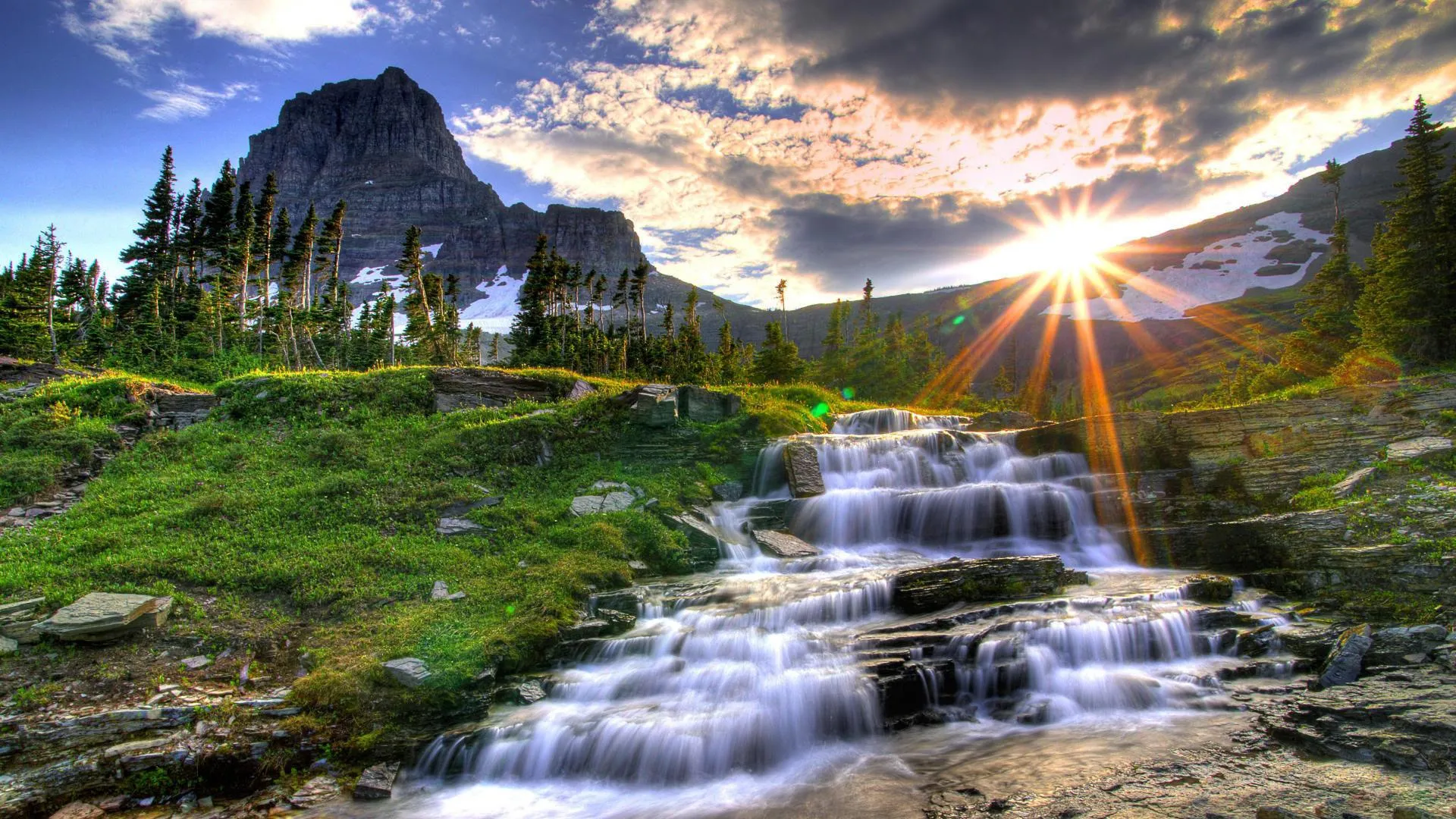 Mountain waterfall cascading down rocky terrain image