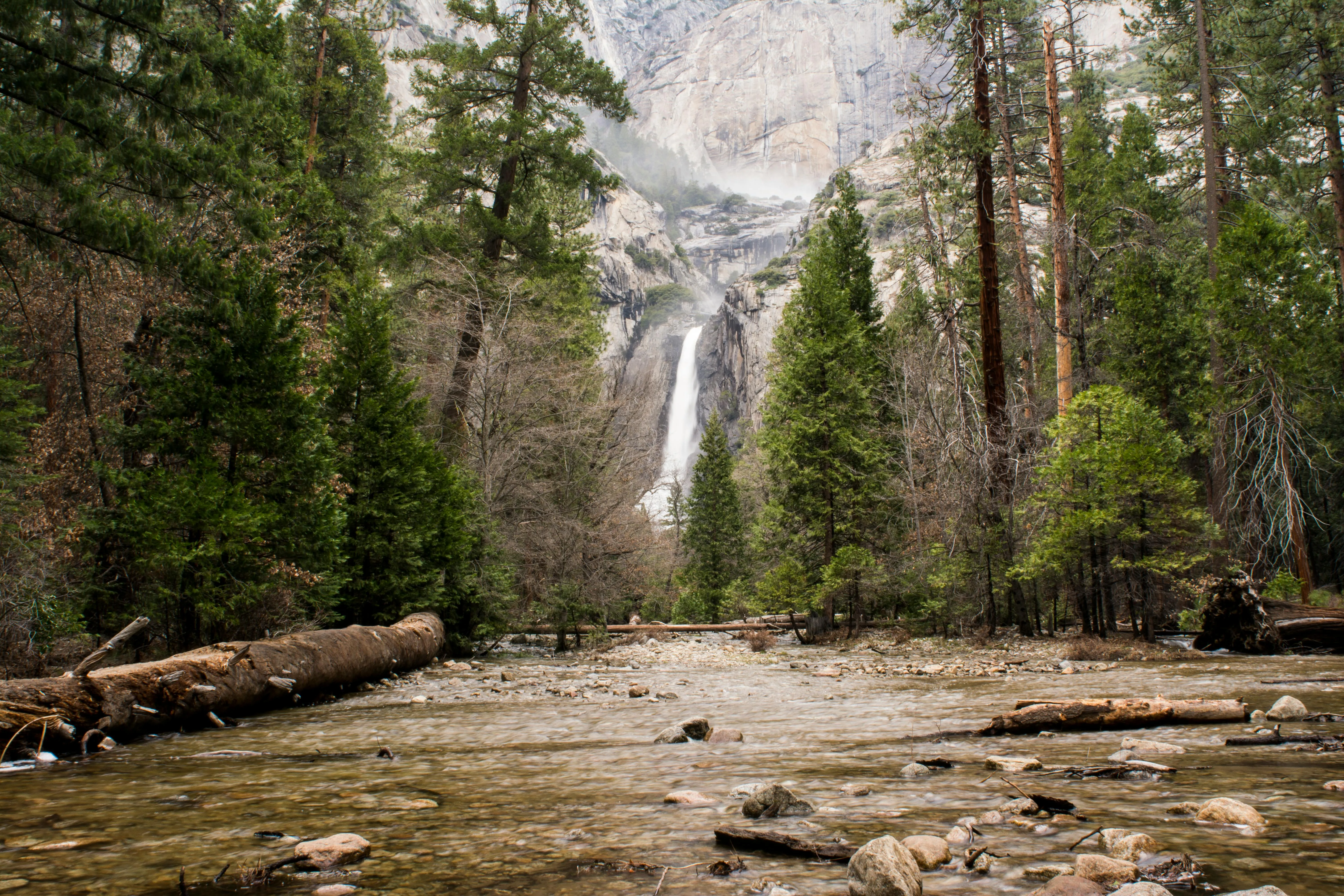 Mountain Waterfall Flowing Through Rocky Forest Valley Path