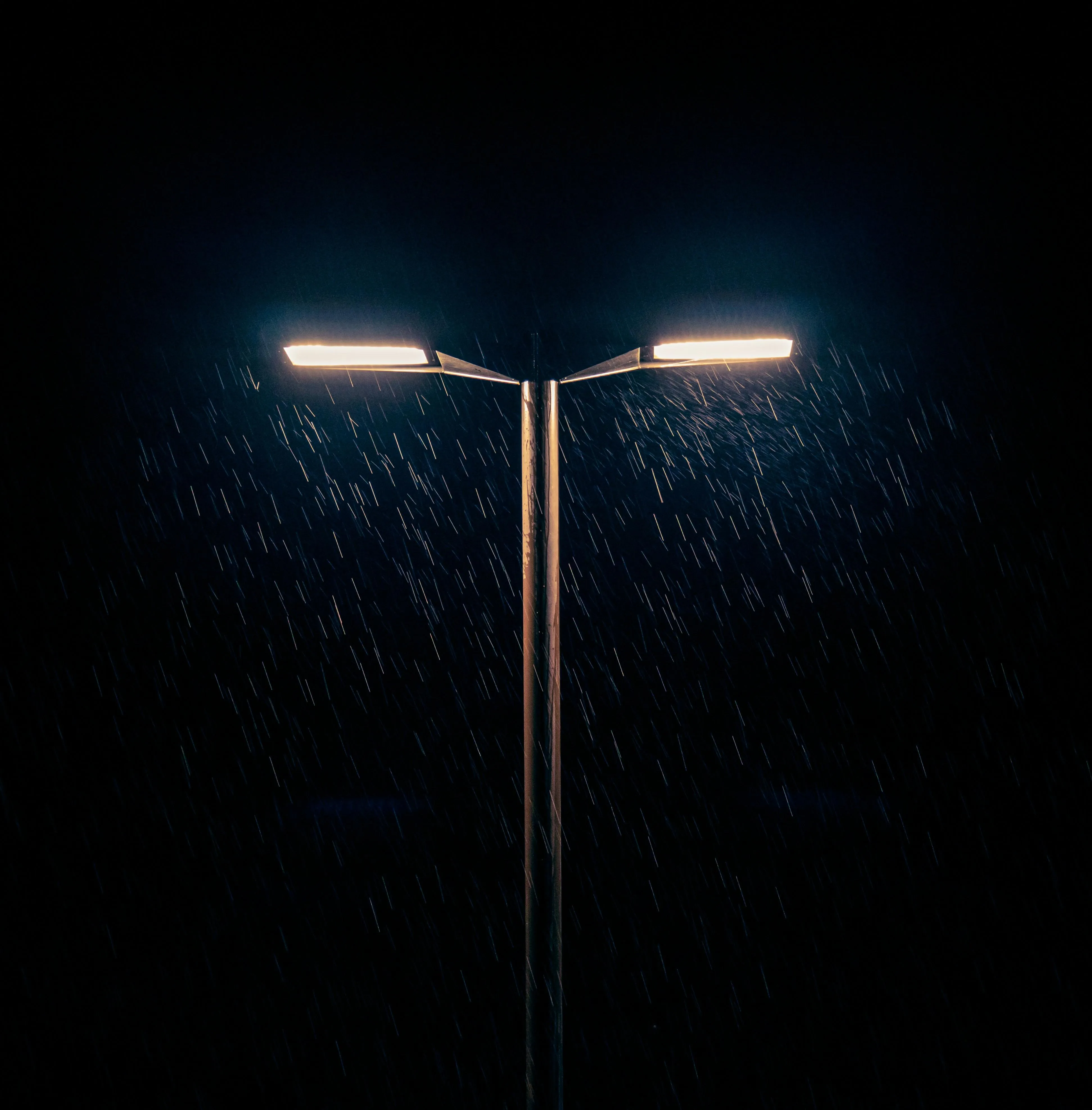 Night Lamp Post Shining in Rainy Dark Urban Environment