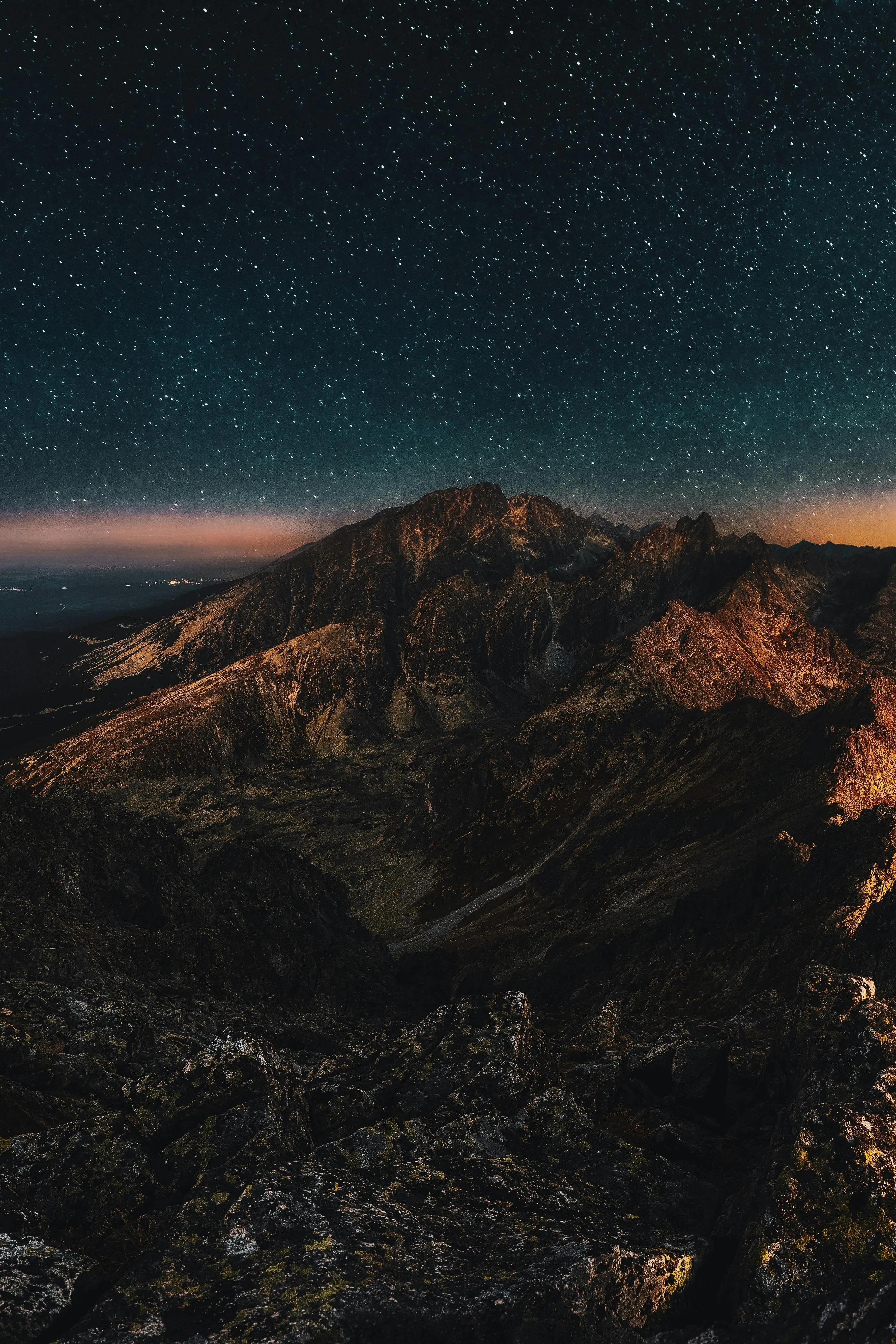 Nighttime View Over Mountains with Star Filled Sky Image