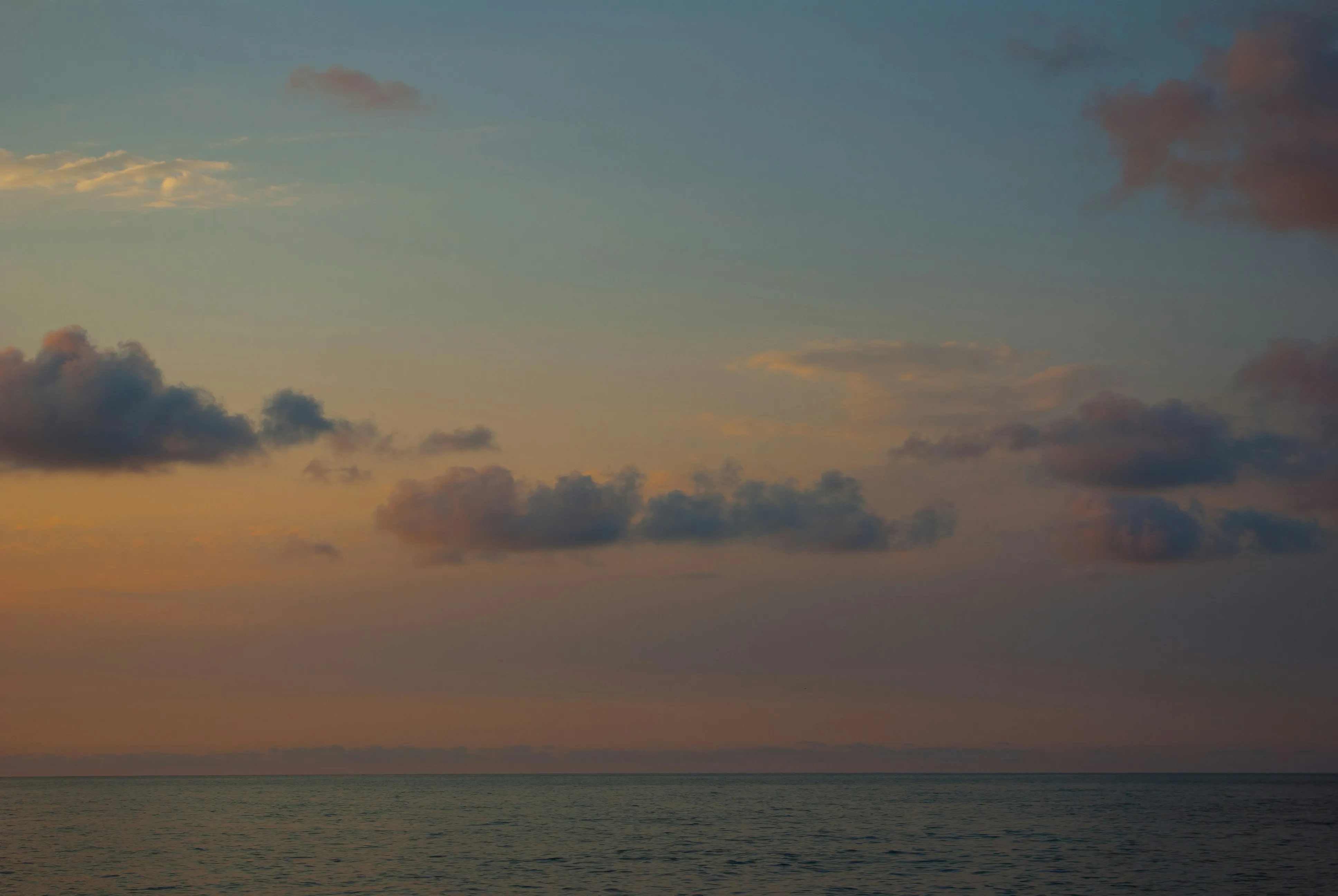 Ocean Horizon with Soft Clouds During Sunset Wallpaper