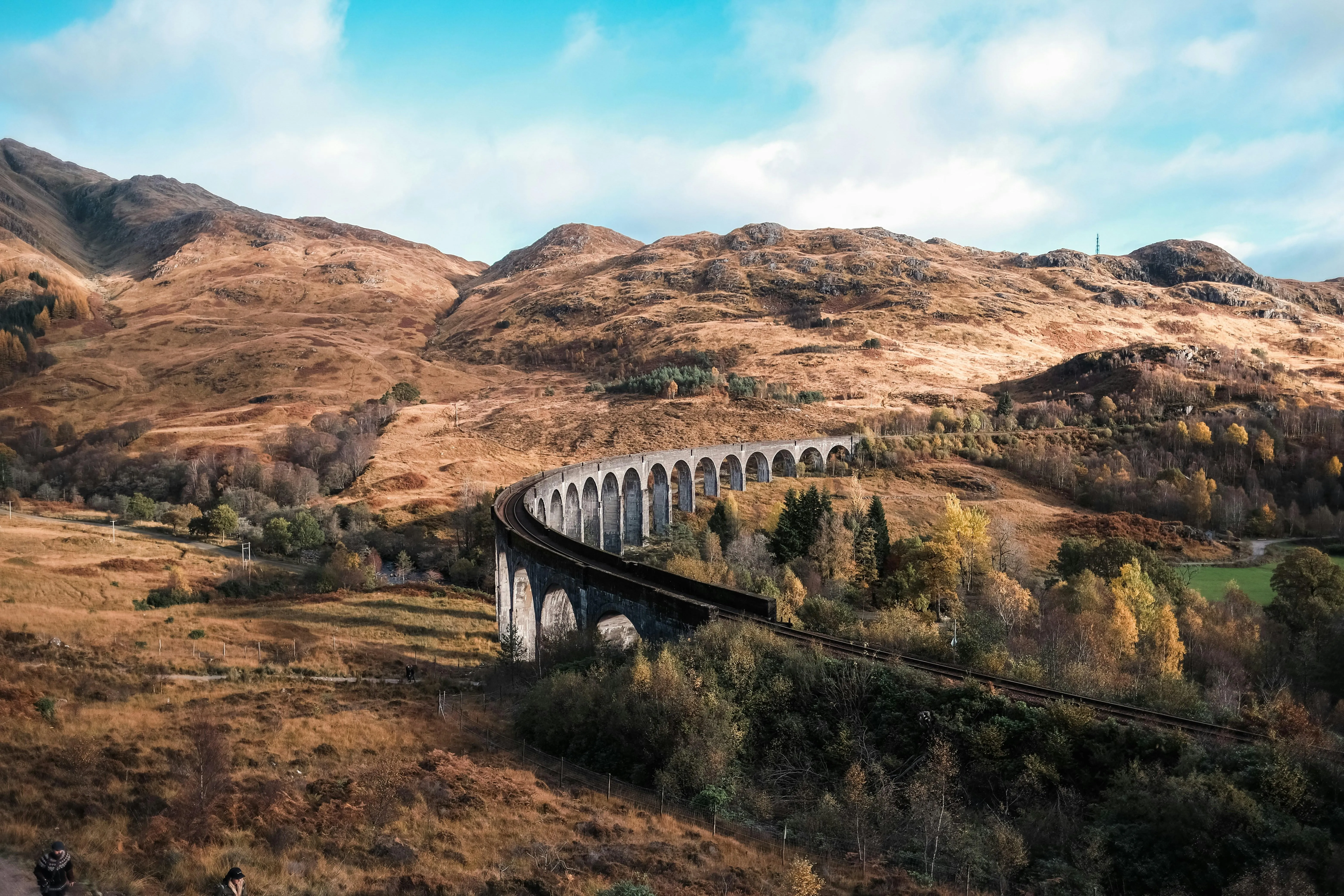 Old Stone Bridge Over Calm River in Mountain Valley