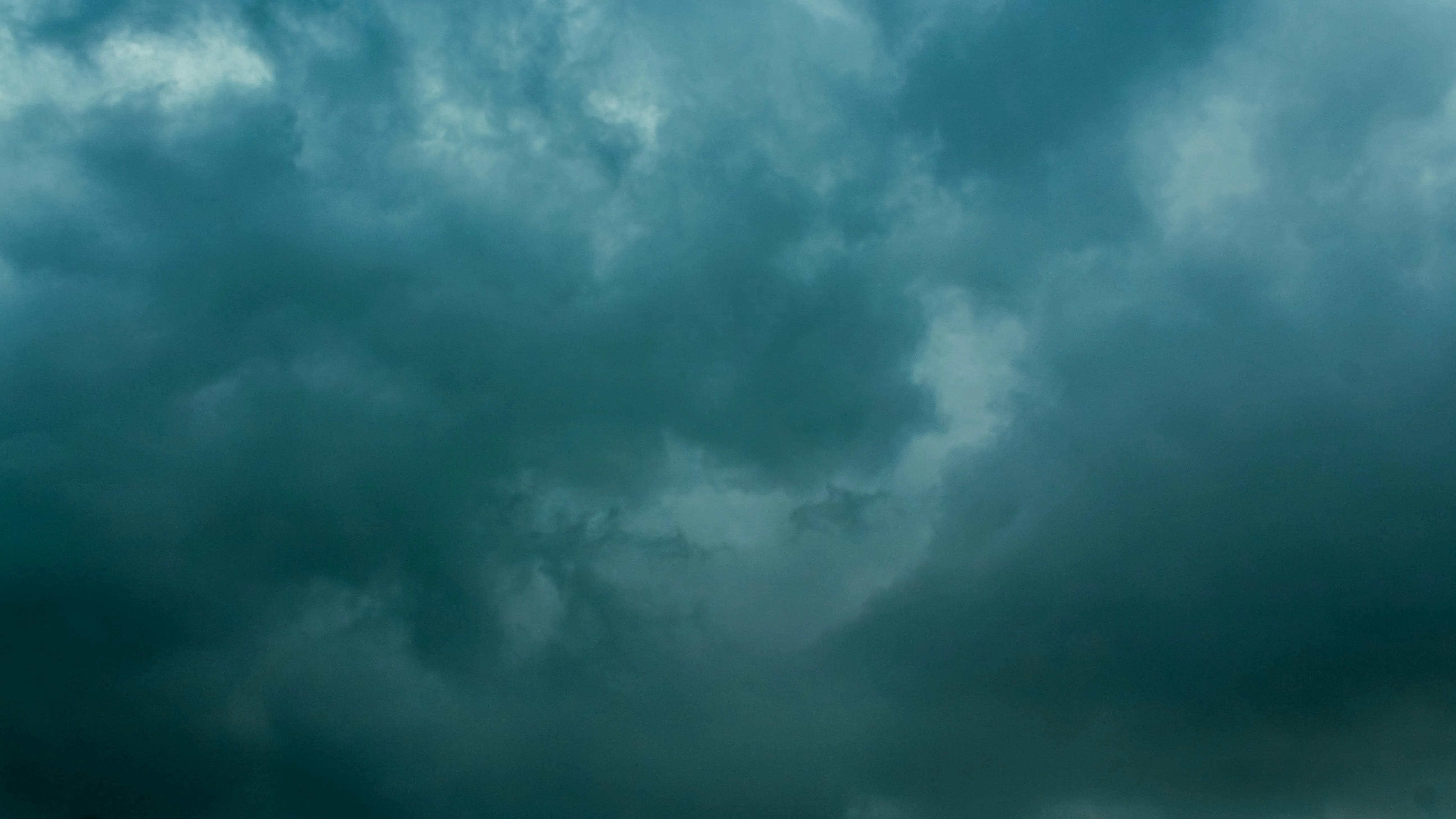 Ominous Green Tinted Sky Filled with Thick Storm Clouds