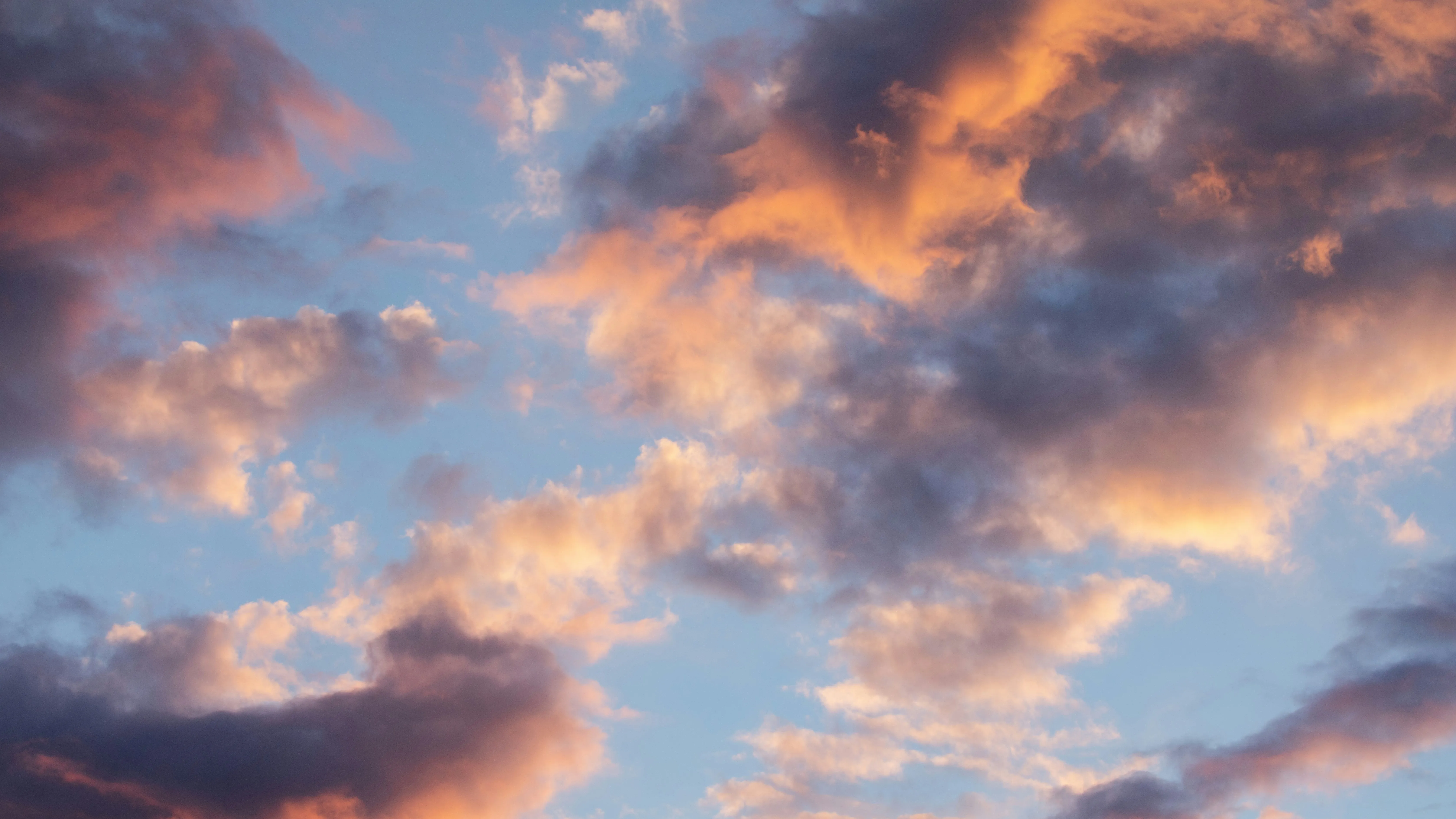 Orange and Pink Sunset Clouds Against Blue Sky Wallpaper
