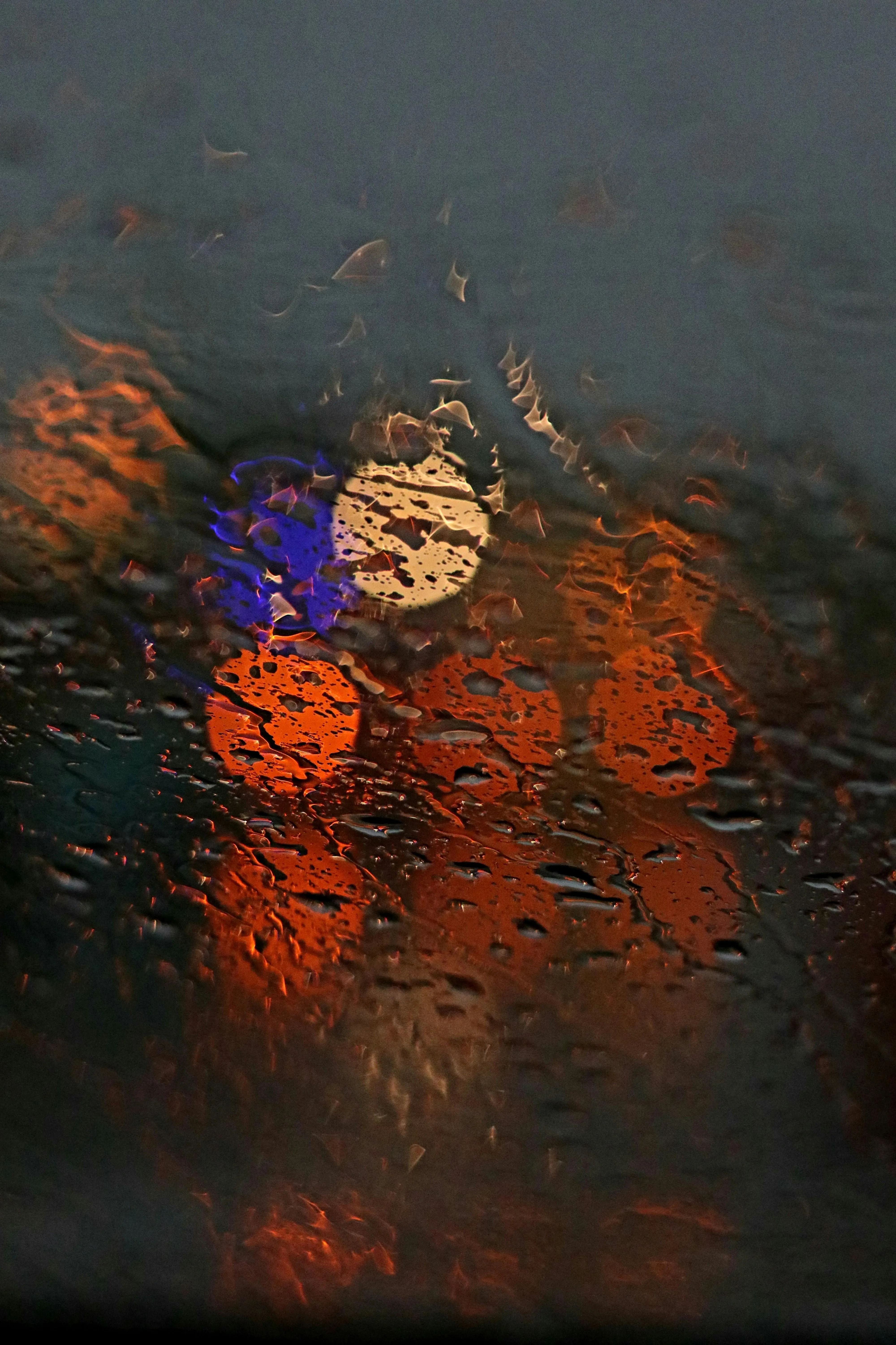 Orange Bokeh Street Lights Seen Through Rain Drops