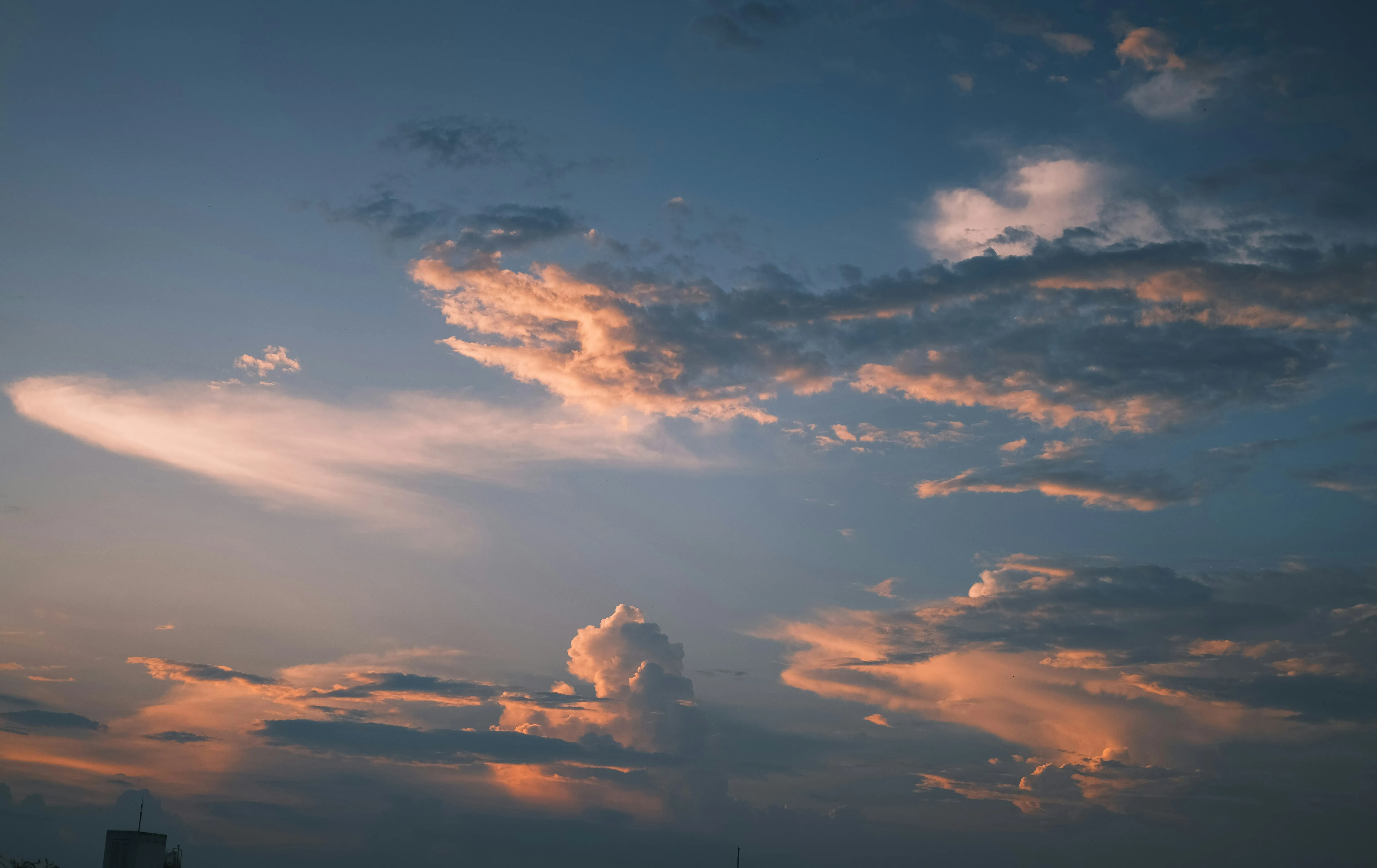 Orange Clouds Against Dark Blue Sky During Evening Sunset
