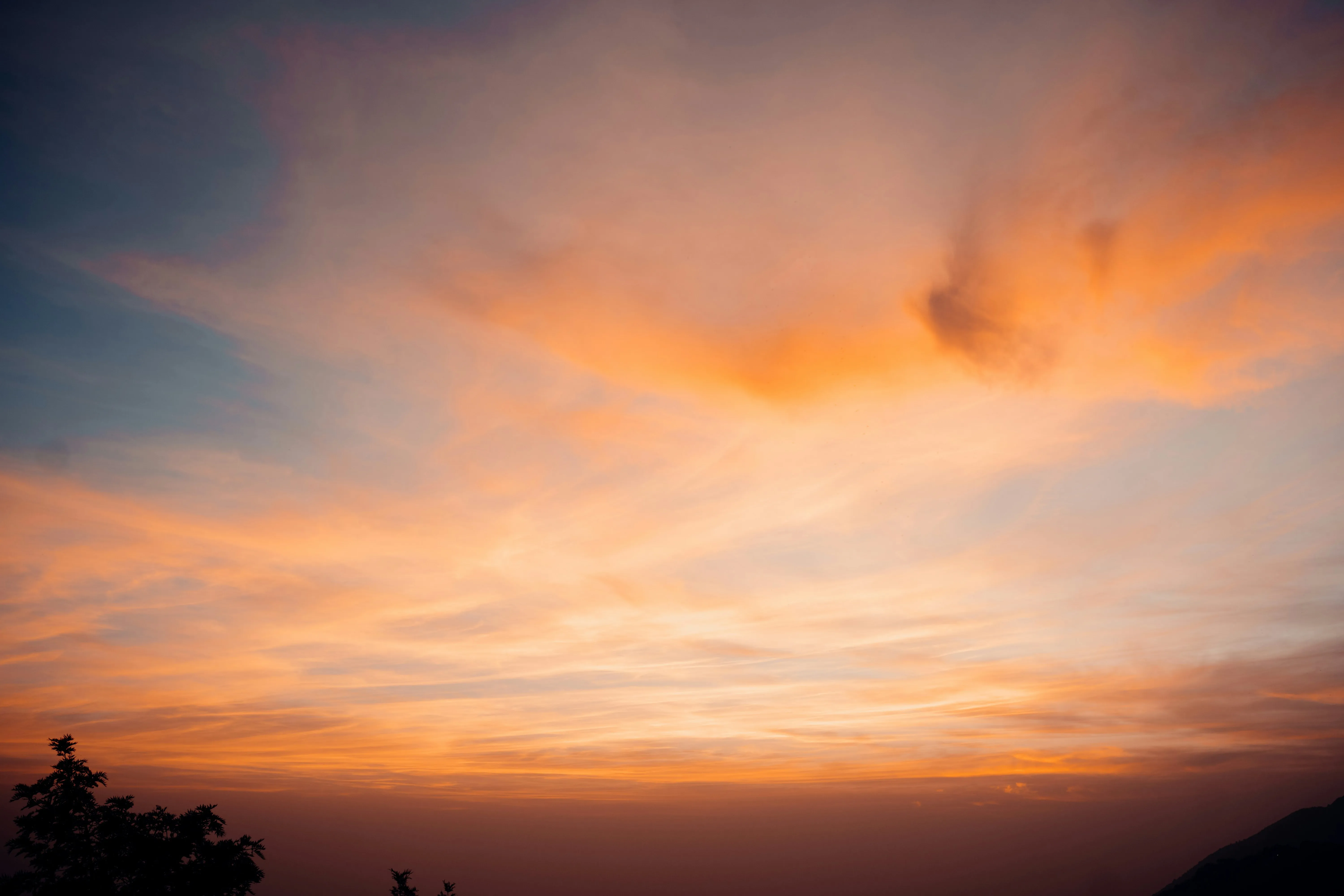 Orange Glow in Sky During Sunset Over Calm Silhouette