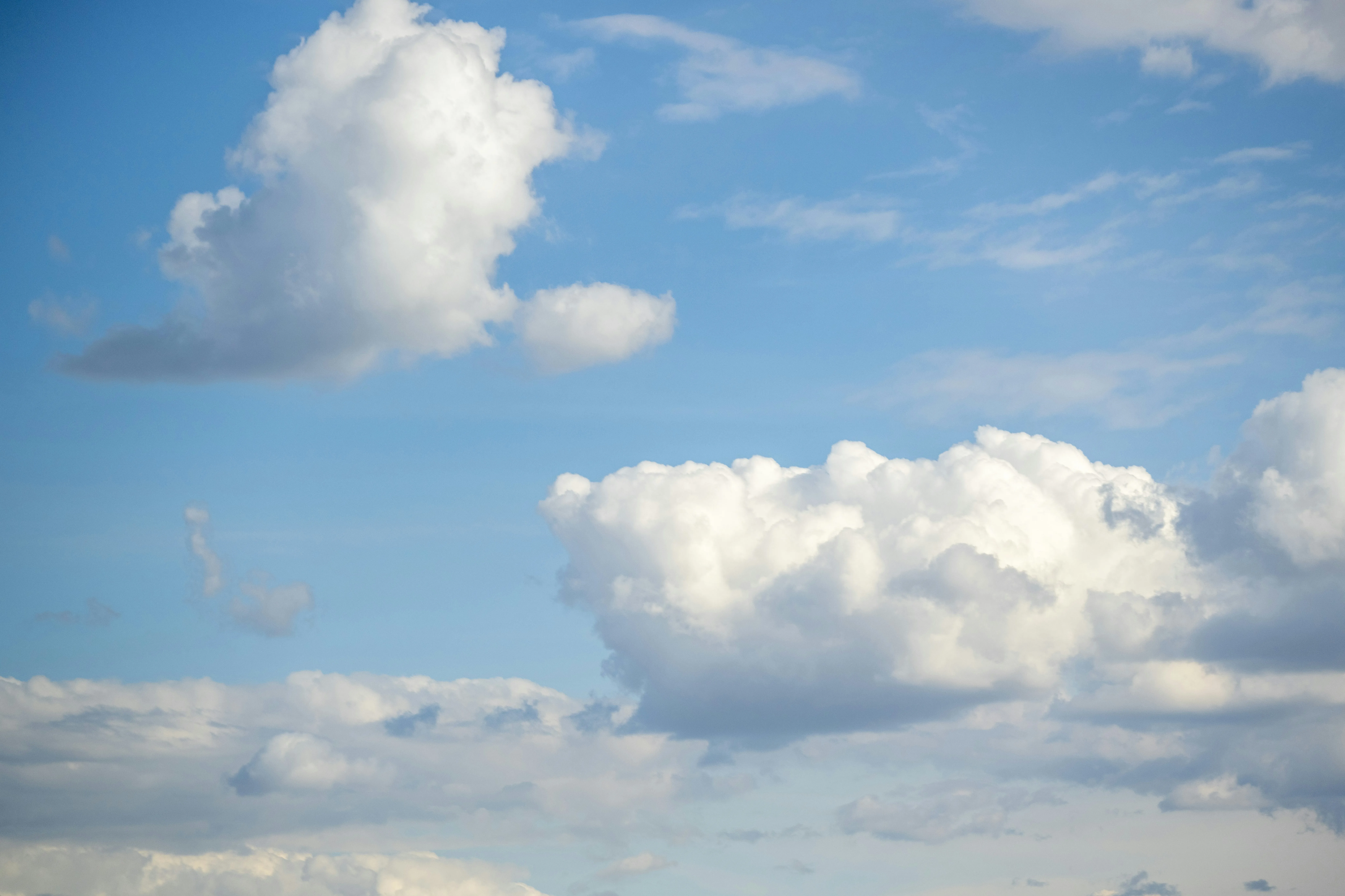 Partly Cloudy Afternoon with Blue Sky Over Open Field
