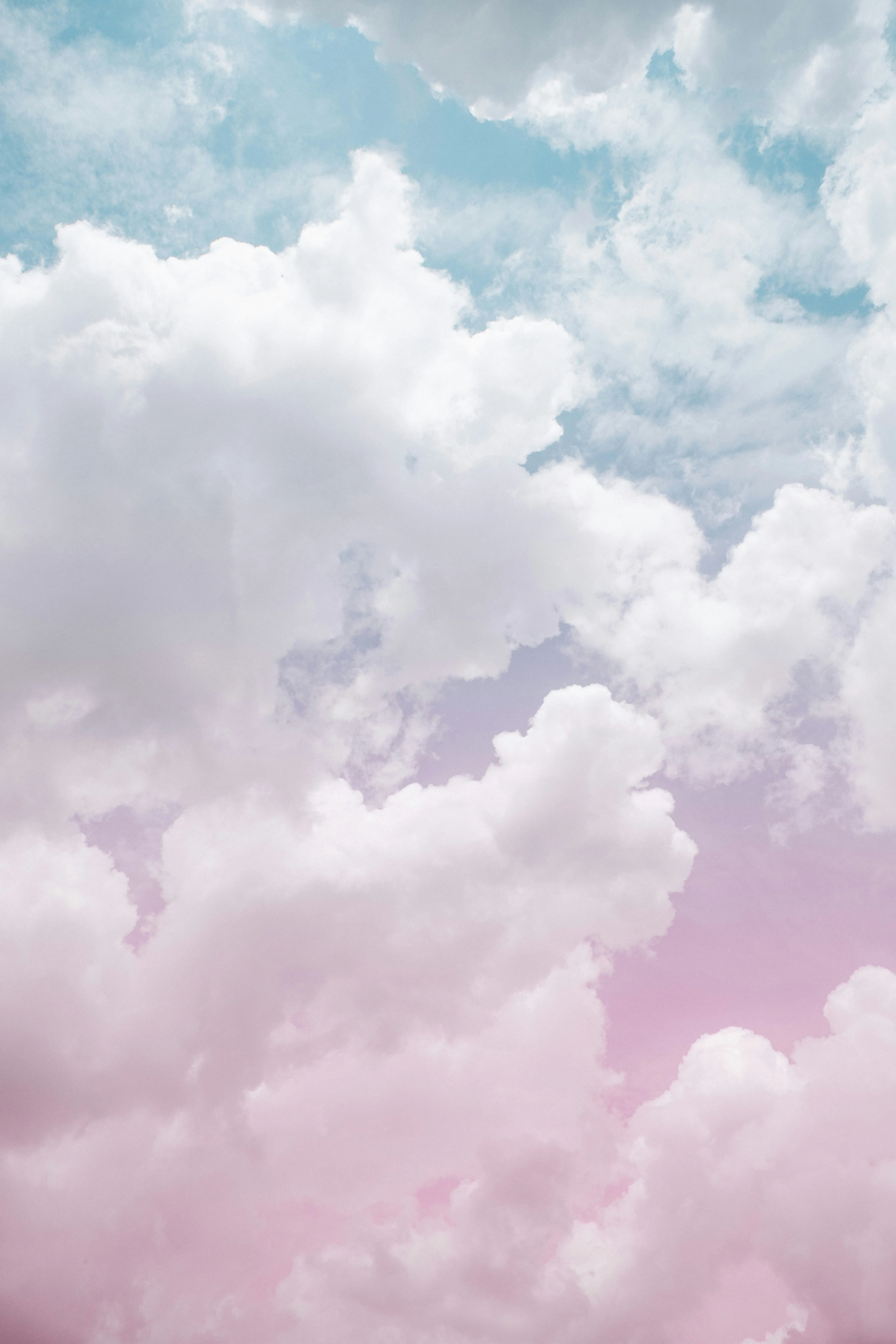Pastel Colored Clouds in Soft Blue Sky Creating Dreamy Scene