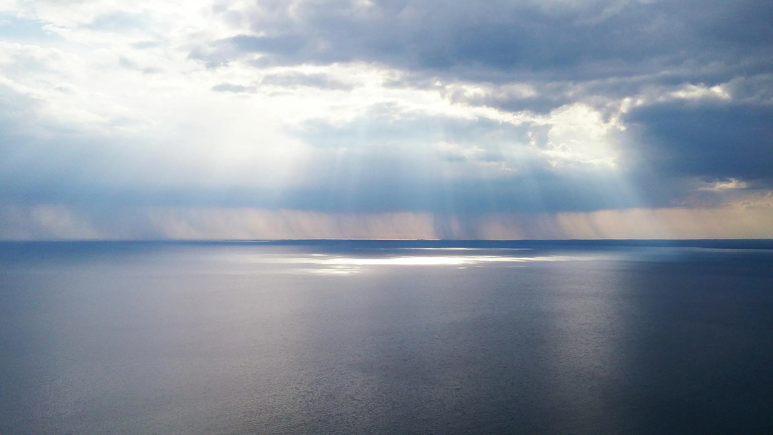 Peaceful Cloudscape Over Calm Ocean Waters Wallpaper