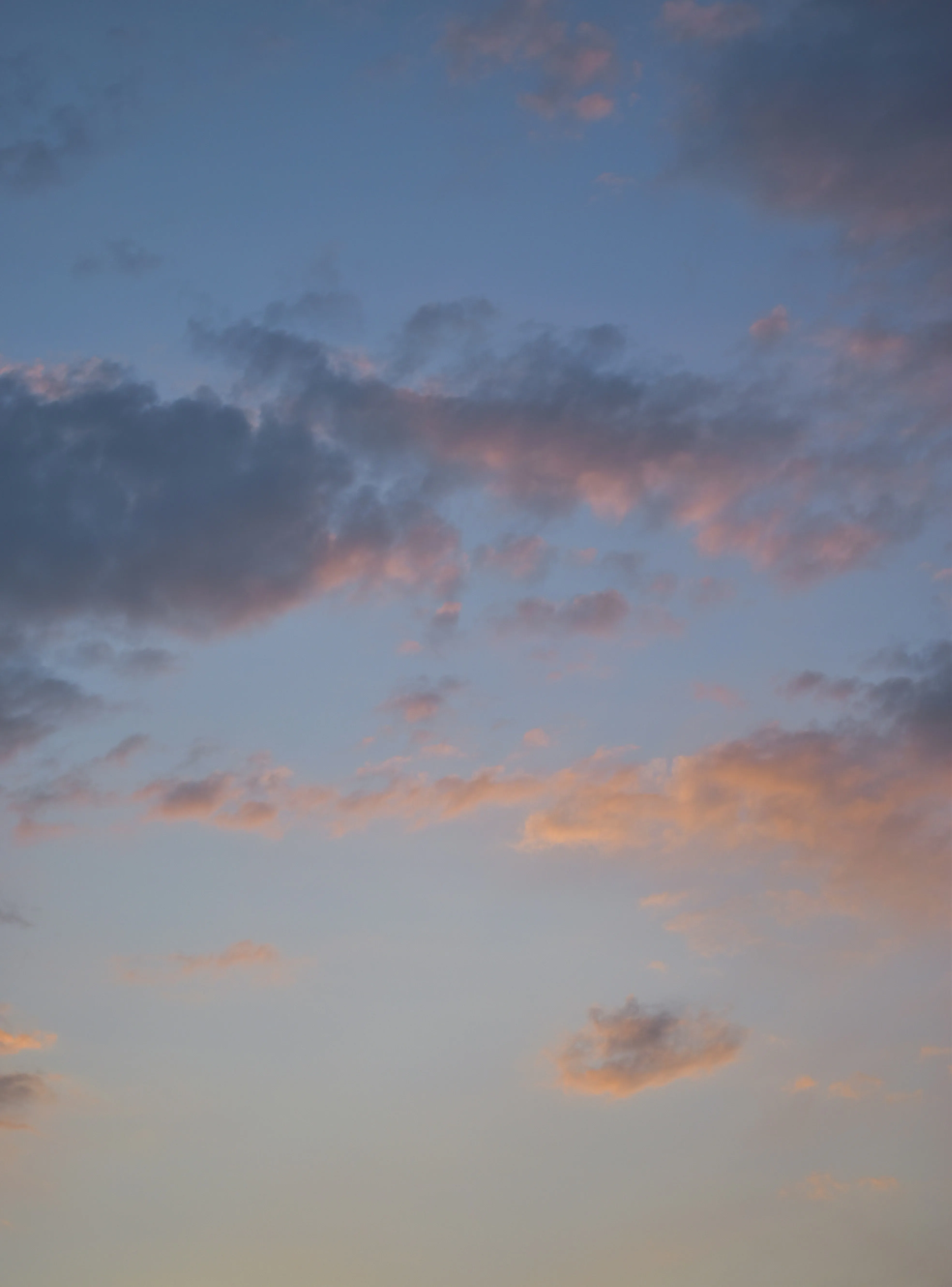 Peaceful Evening Sky with Clouds Glowing in Soft Light