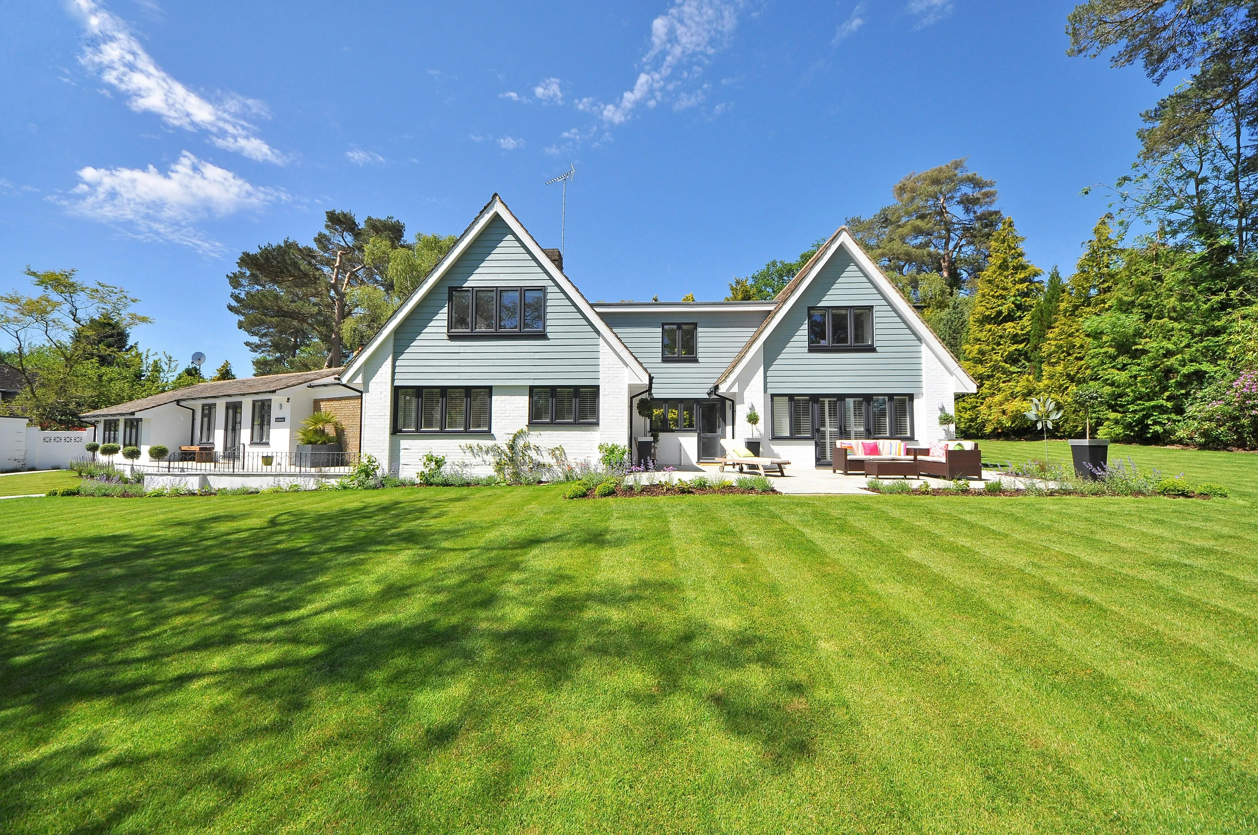 Peaceful Suburban Sky Over Green Lawn and Modern Homes