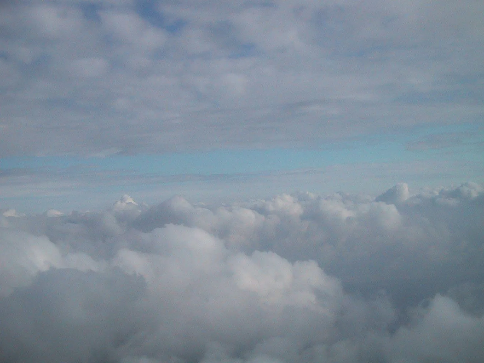 Peaceful View Above the Clouds Under a Blue Sky Image