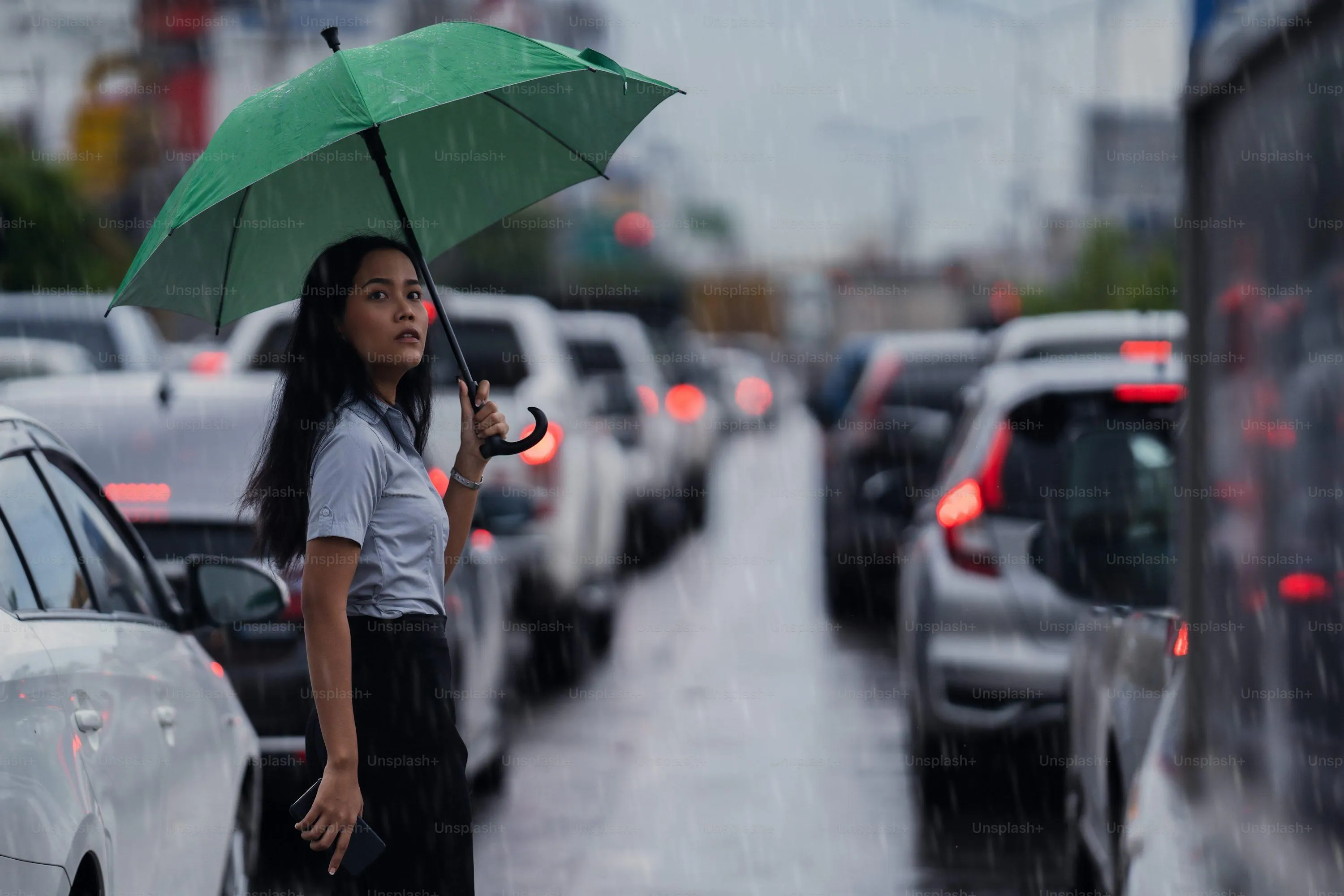 People Walking with Umbrellas in Busy Street Rain