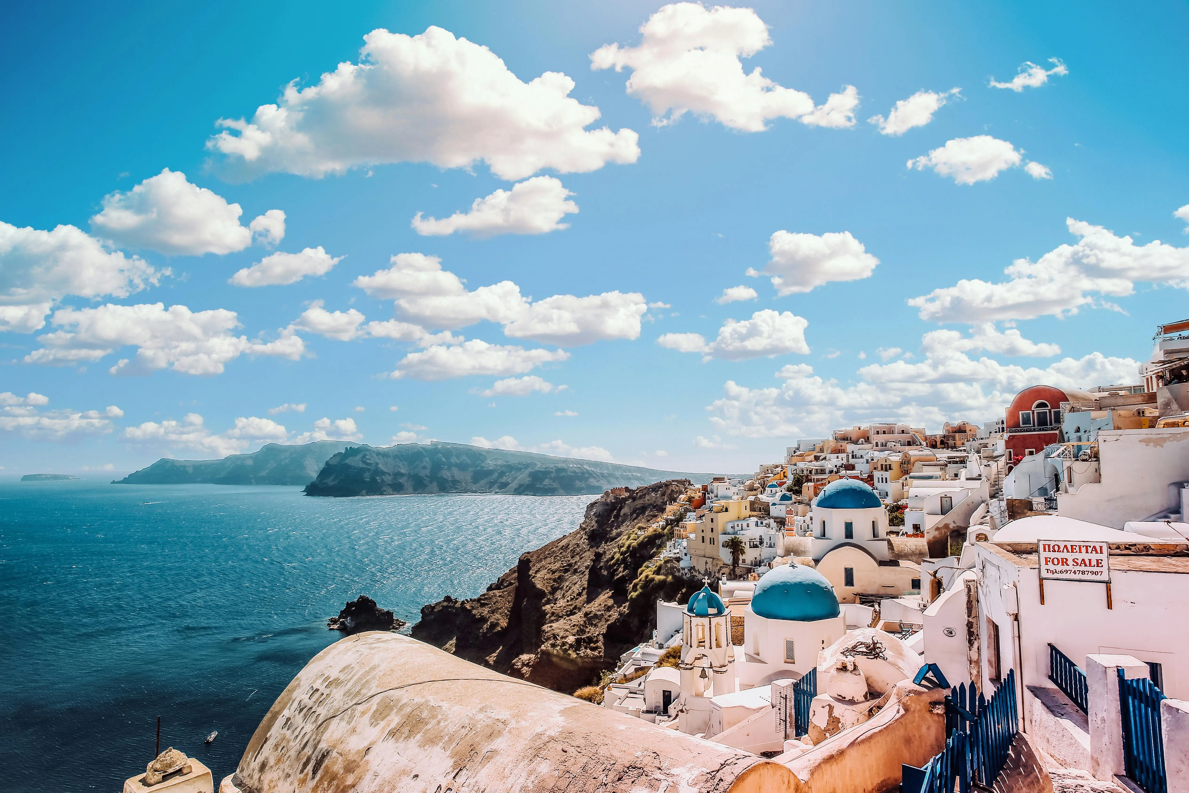 Picturesque Coastal Town Under Bright Blue Sky and Clouds