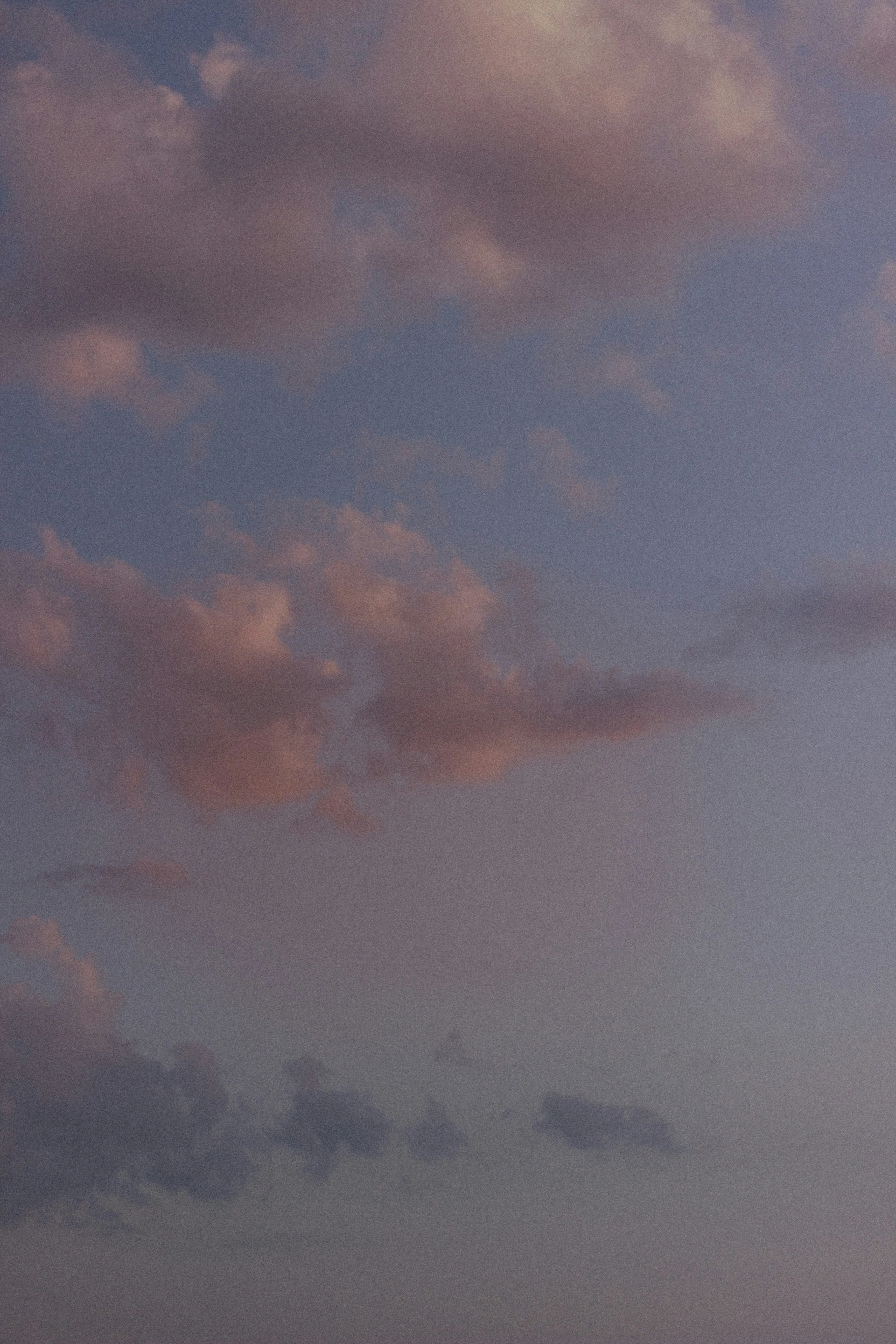 Pink and Orange Colored Clouds in Evening Sky Over Landscape