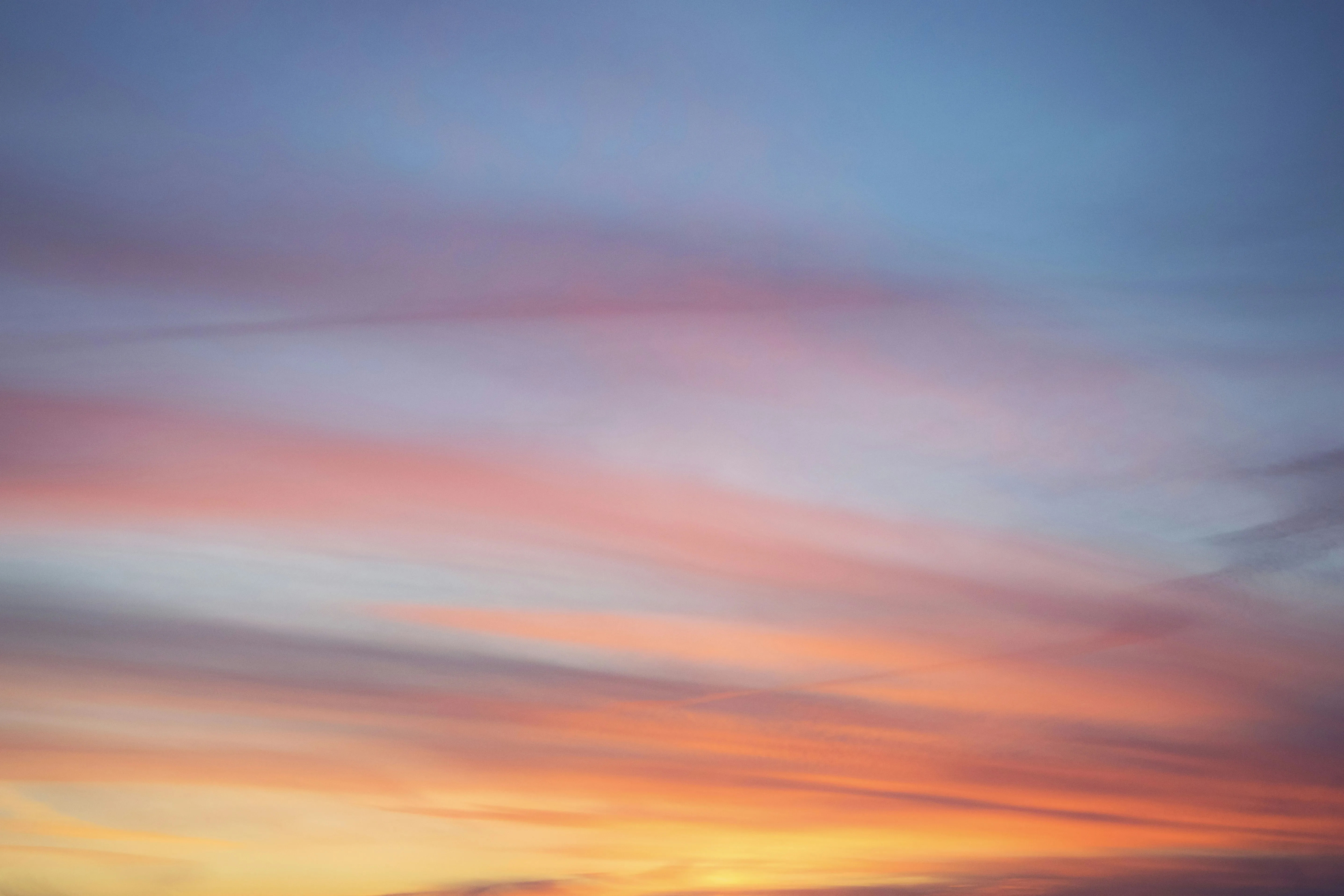 Pink and Orange Sunset Sky with Gentle Cloud Streaks