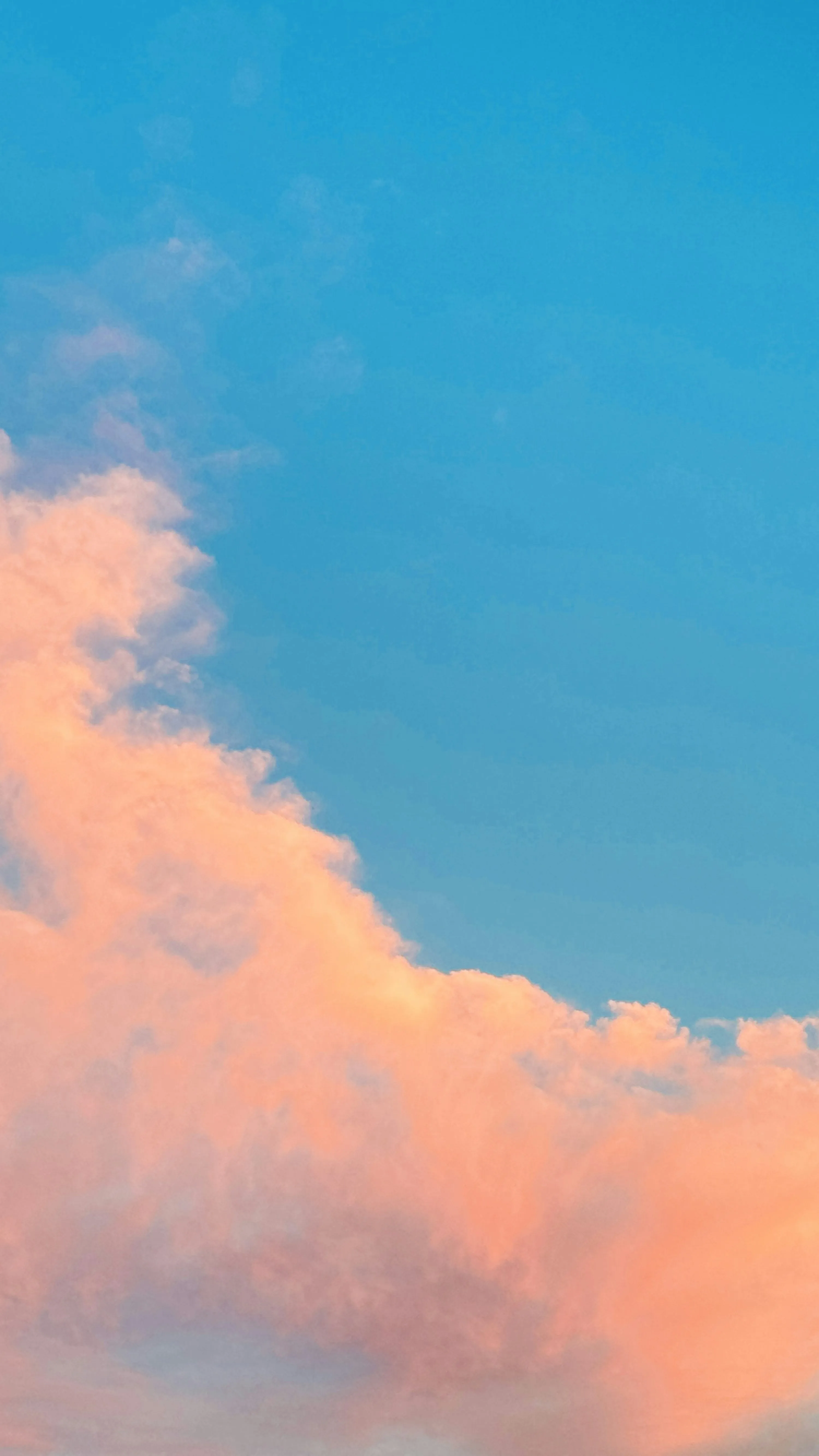 Pink Clouds Against Bright Blue Sky on Sunny Day Image