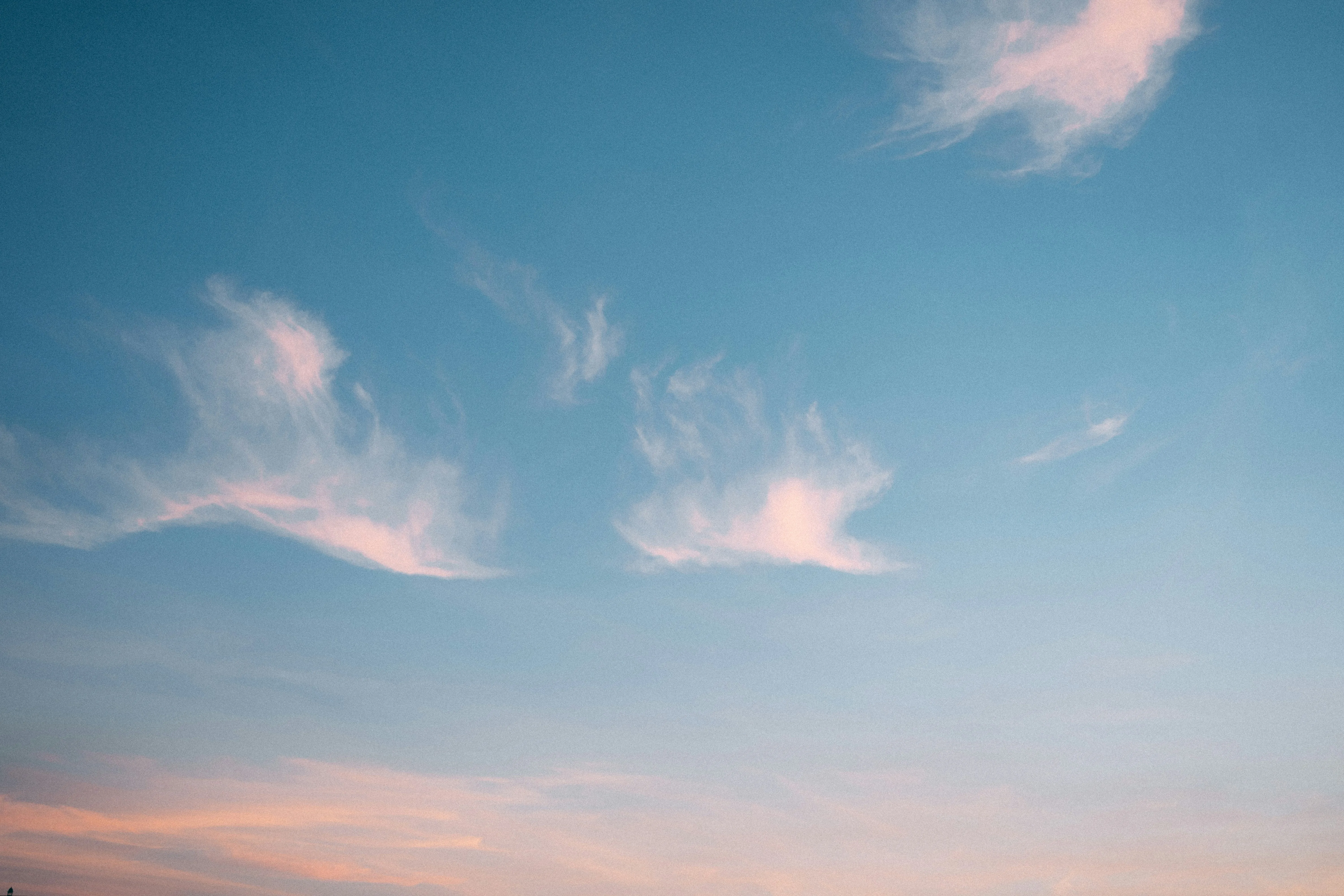 Pink Clouds Drifting Across a Pastel Evening Sky Wallpaper
