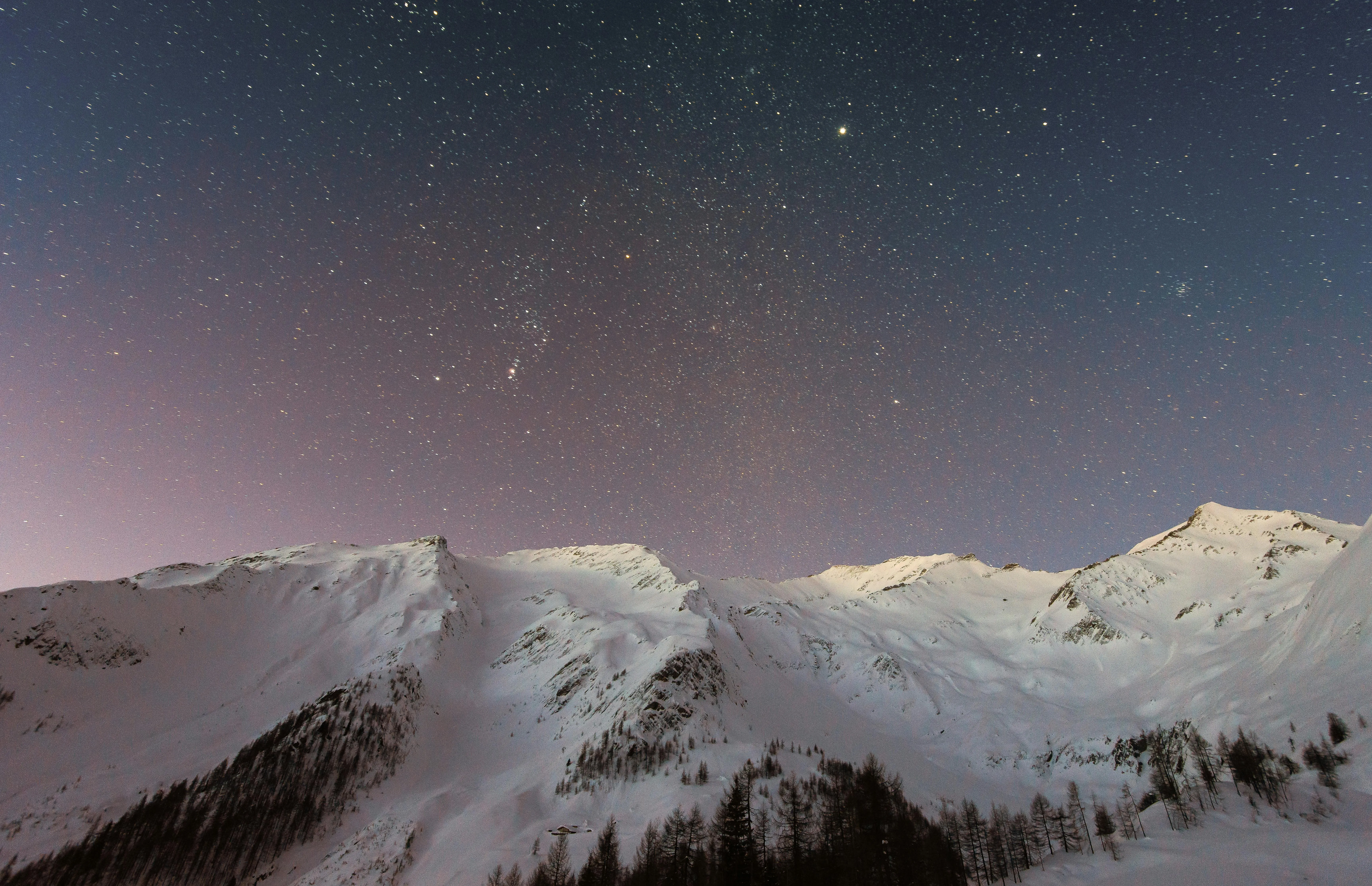 Pink Dusk Sky Over Snowy Mountains with Calm Cloud Scene