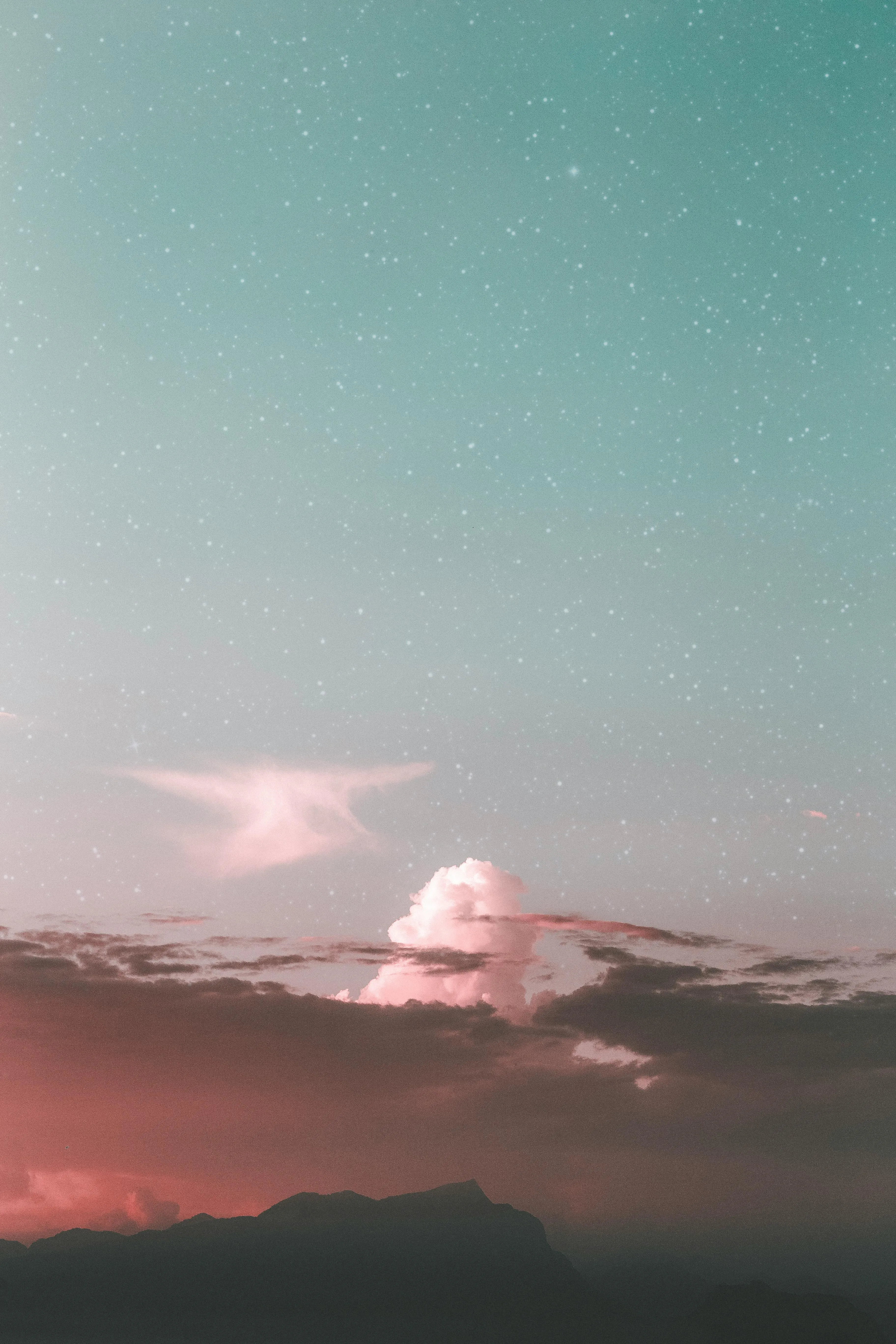 Pink Sky with Storm Clouds Above Distant Mountains Image