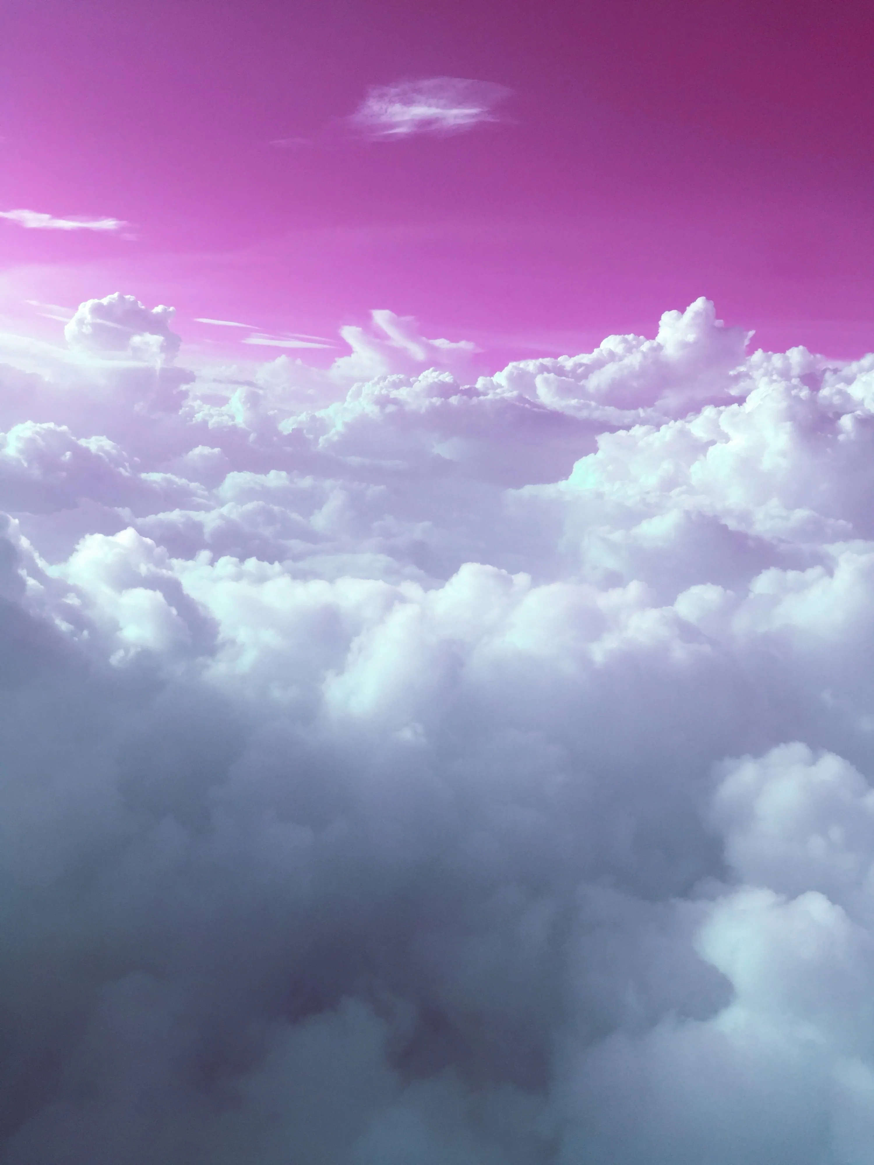 Puffy Clouds Under a Violet and Pink Colored Sky Image