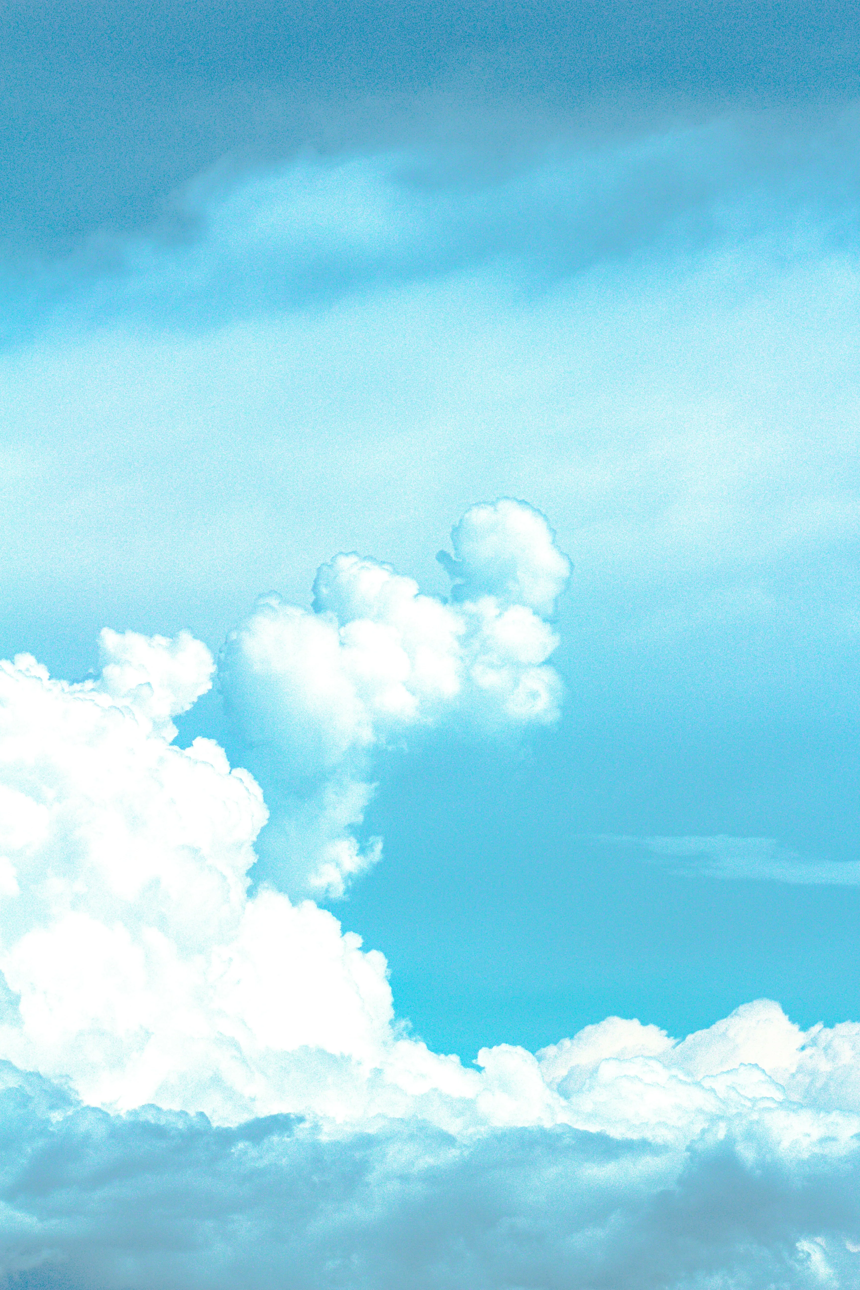 Puffy Cumulus Clouds Rising in a Bright Blue Sky Wallpaper