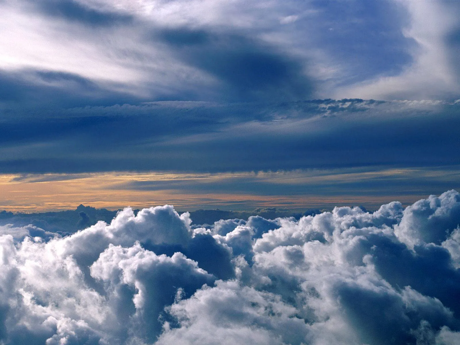 Puffy White Clouds Above a Blue Sky with Mountain Range