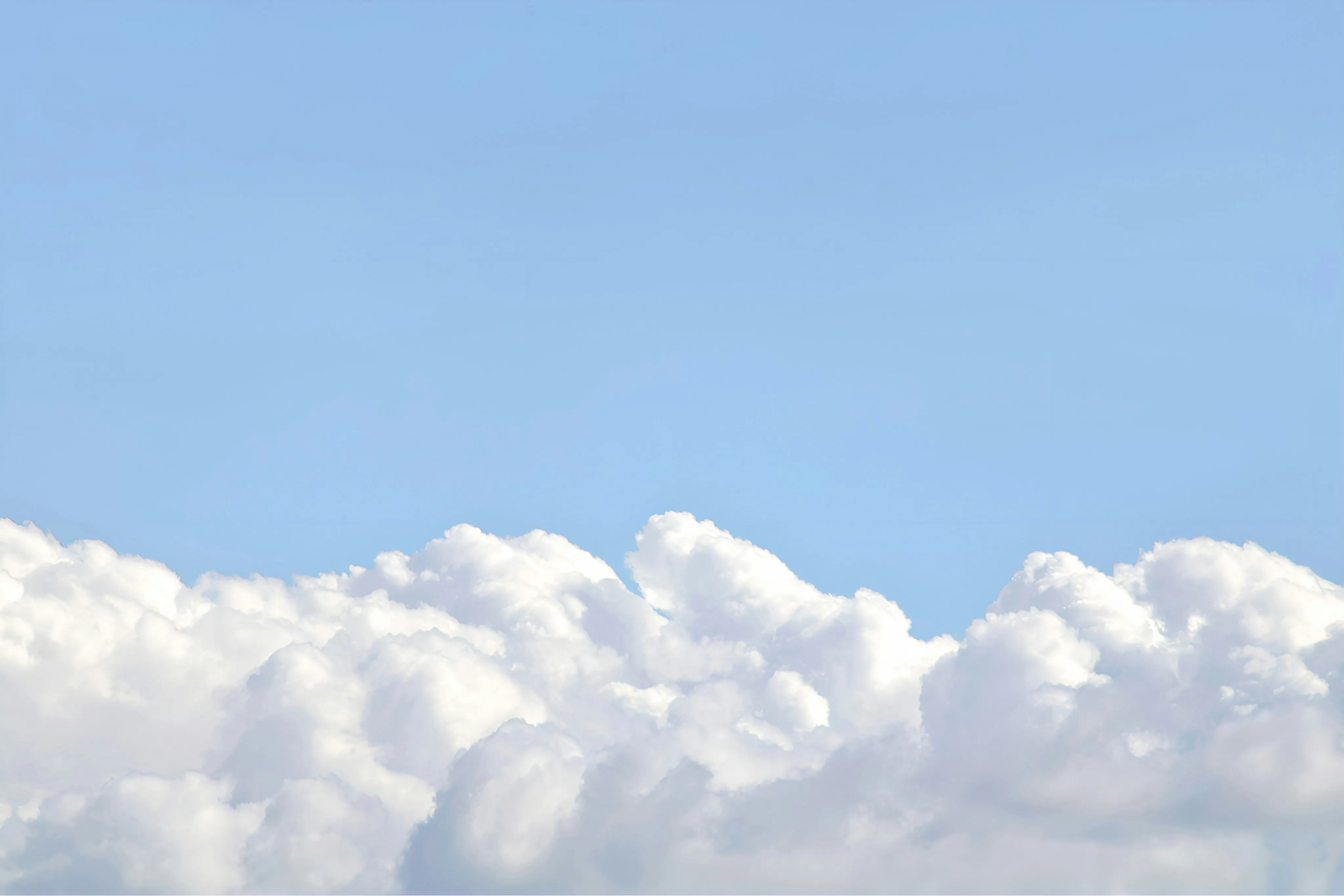 Puffy White Clouds Drifting in a Calm Afternoon Sky