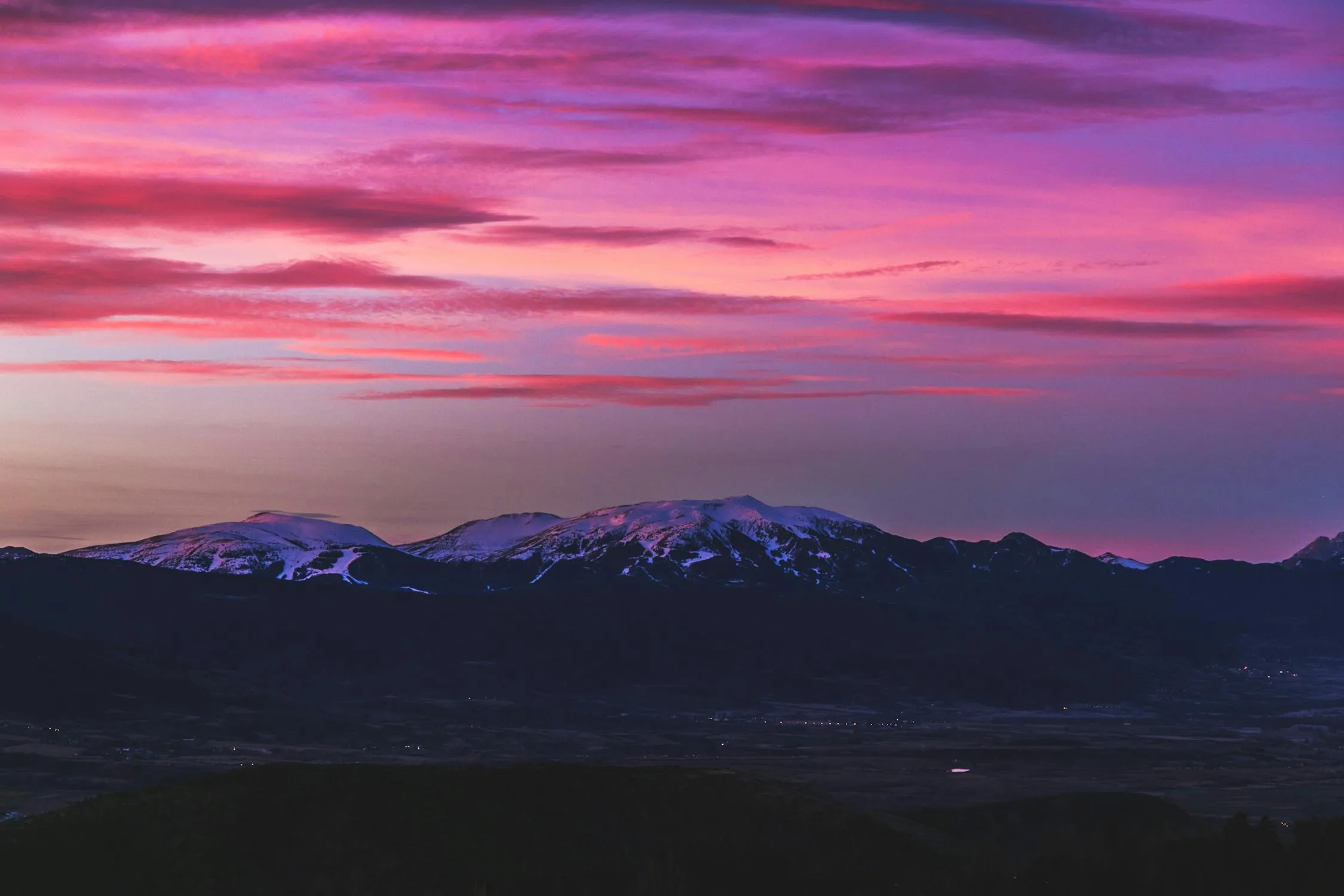 Purple and Pink Sunset Over Mountain Landscape Image