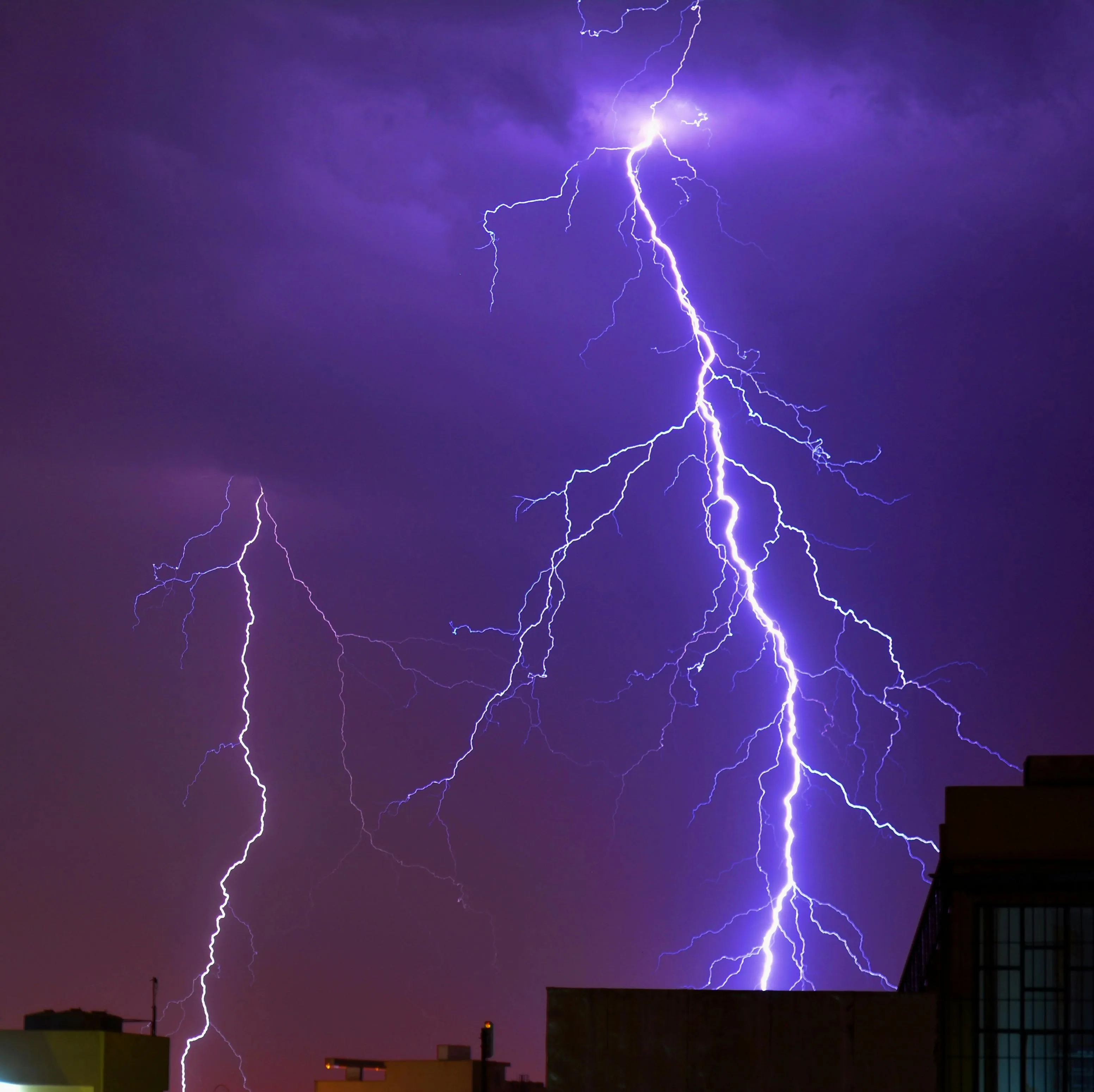 Purple Lightning Strike Cutting Through Storm Clouds