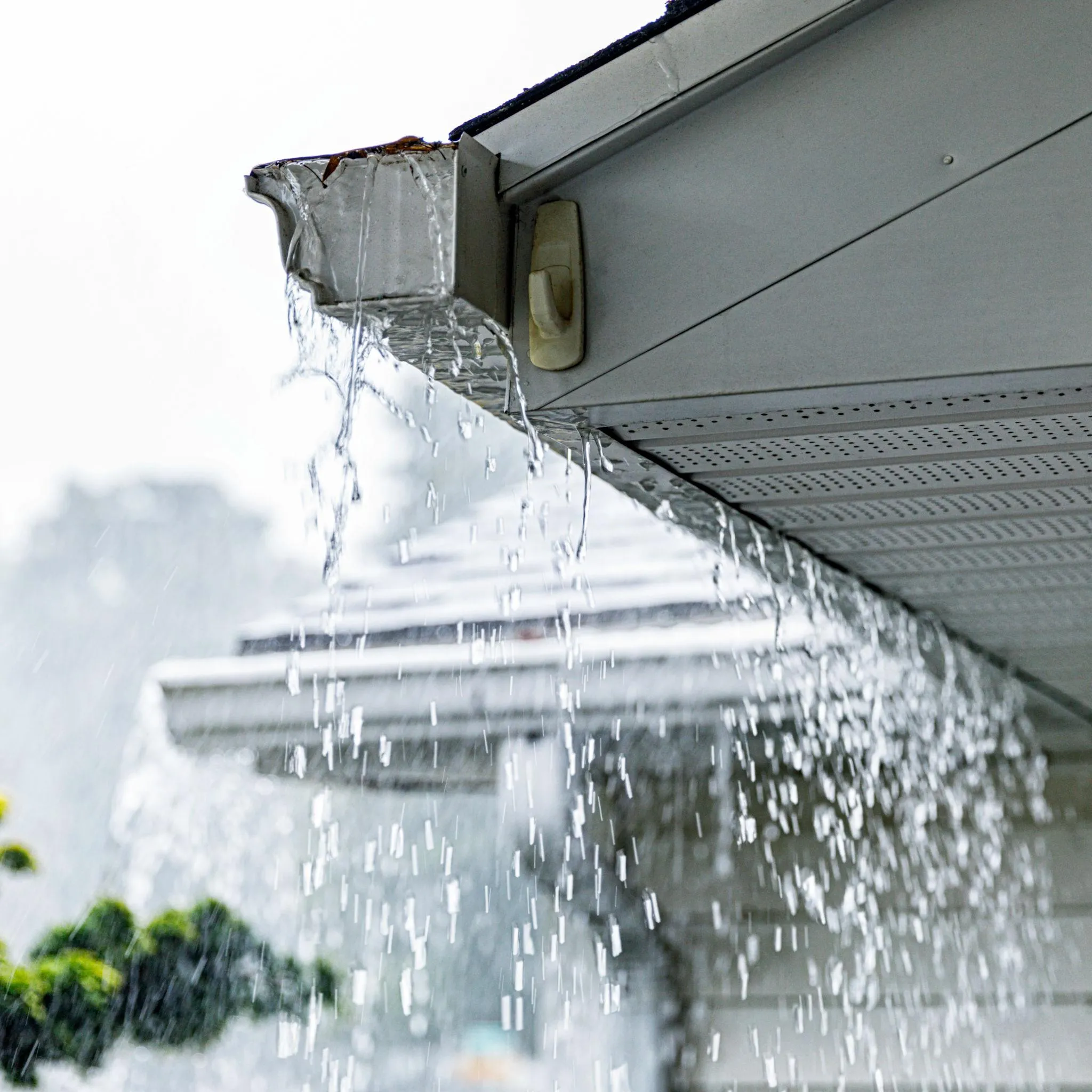 Rain Falling From House Gutter During Stormy Weather
